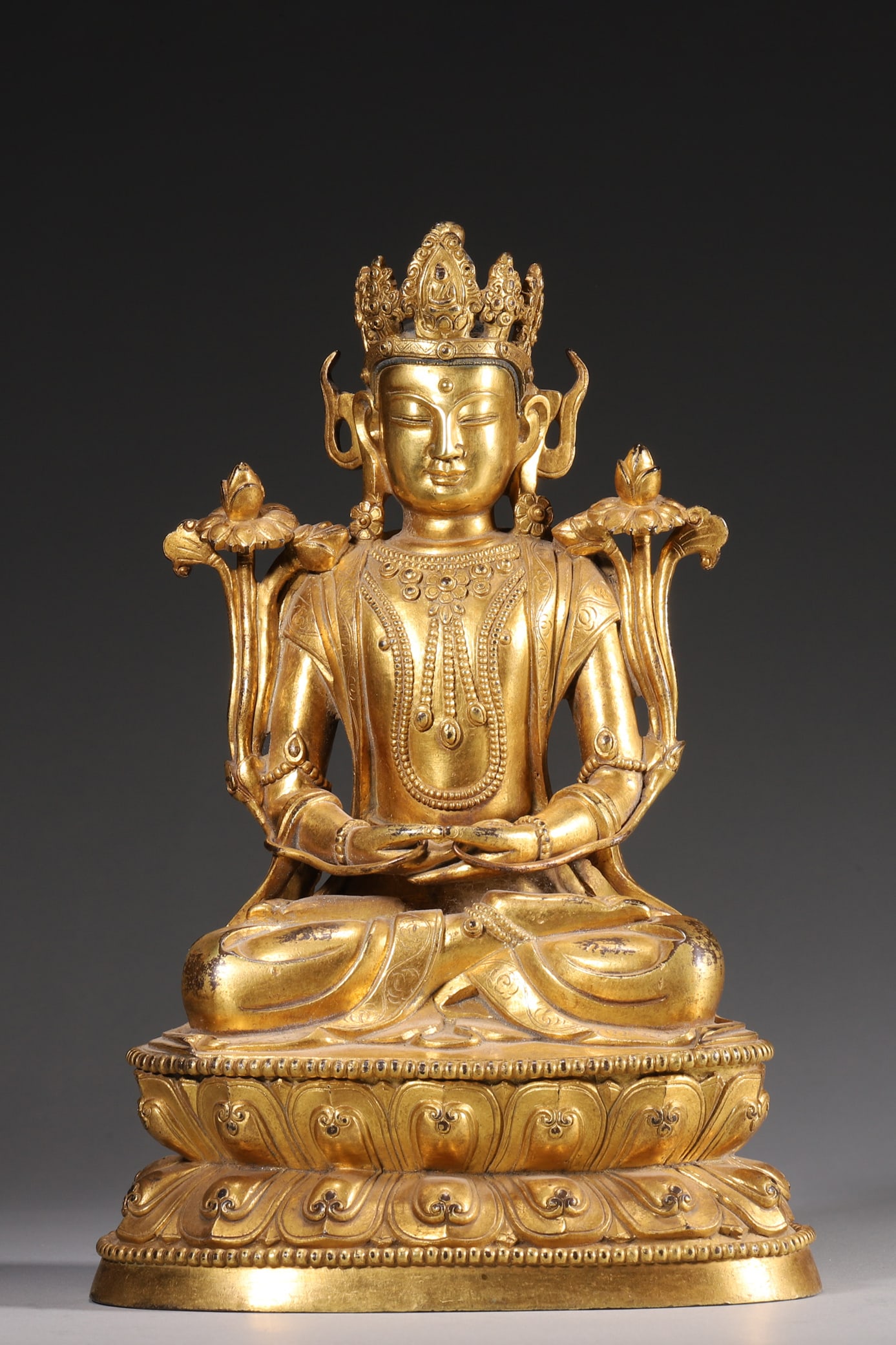 A Gilt Bronze Amitayus Statue - Qing Dynasty: Length 15.0cm (5.91in), Width 11.0cm (4.33in), Height 23.0cm (9.06in), Weight 2159.0g (4.76lb)This Amitayus statue is cast in bronze with gilt finish, featuring a serene expression and elaborate ornam