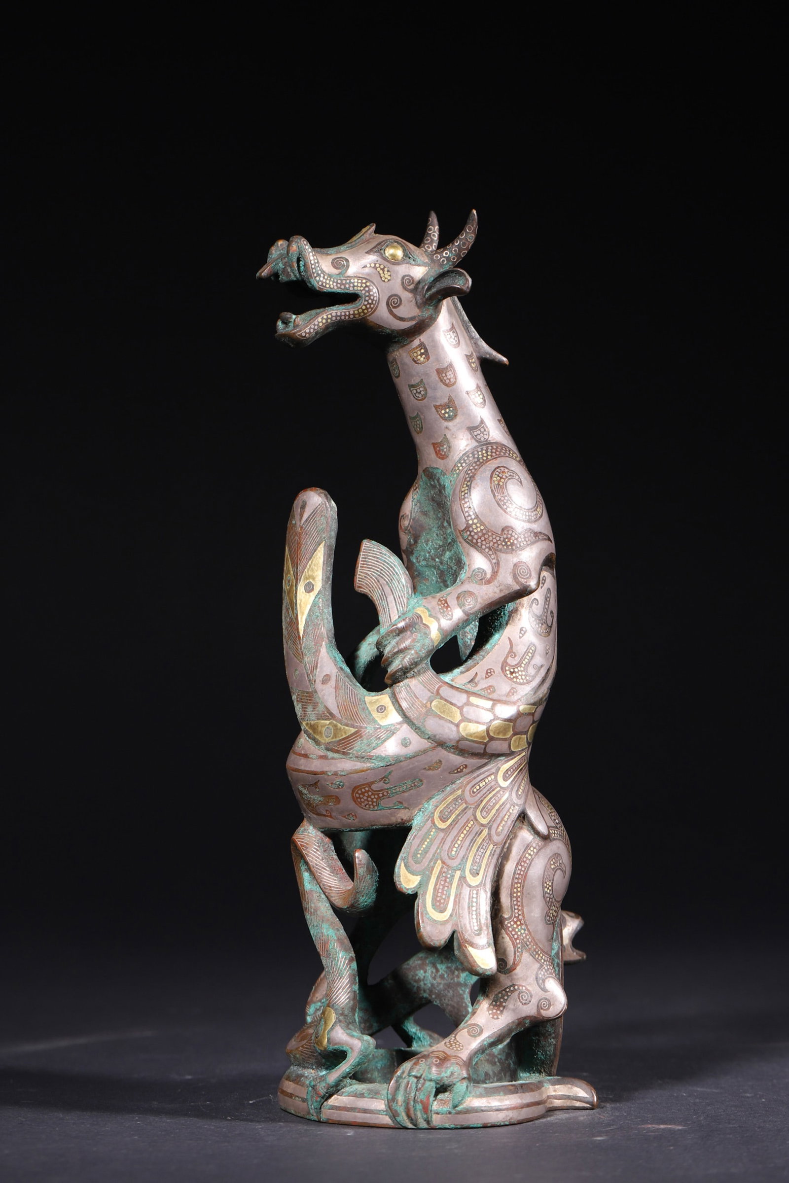 A Gold and Silver Inlaid Bronze Auspicious Beast Sculpture - Warring States Period: Length 8.5cm (3.35in), Width 8.0cm (3.15in), Height 24.0cm (9.45in), Weight 2095.0g (4.62lb)This Warring States bronze sculpture depicts an auspicious beast with dynamic posture, decorated with intric