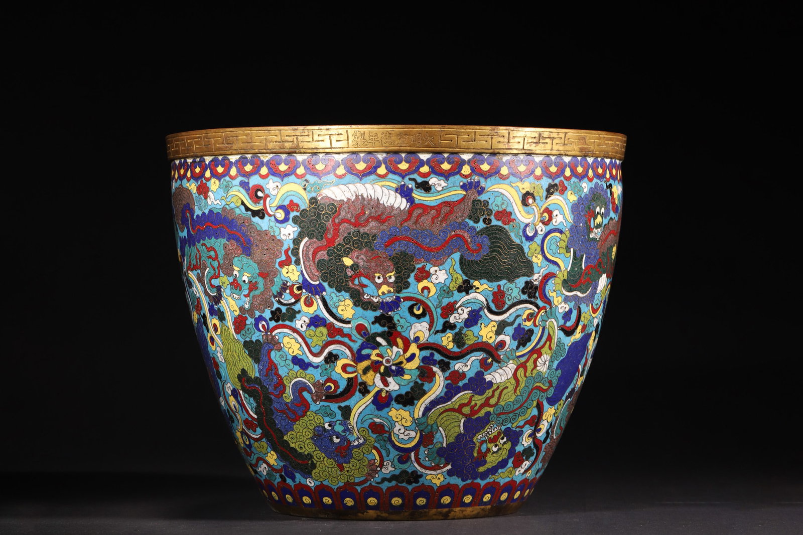 A Gilt-Bronze Cloisonné Enamel Censer with Lion and Ball Design, Xuande Period, Ming Dynasty: Diameter 31.0cm (12.2in), Height 25.0cm (9.84in), Weight 4661.0g (10.28lb)A gilt-bronze cloisonné enamel censer from the Xuande period of the Ming Dynasty. The body is decorated with lions playing wi