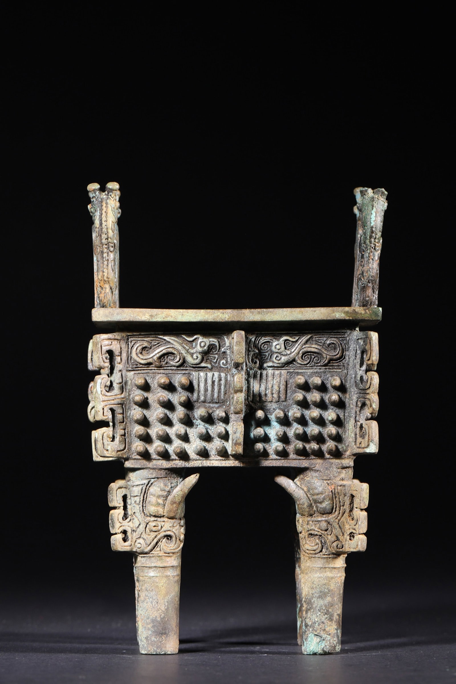 A Bronze Rectangular Ding with Nail-Pattern Decoration - Late Shang Dynasty: Length 9.0cm (3.54in), Width 7.5cm (2.95in), Height 15.0cm (5.91in), Weight 839.0g (1.85lb)This solemn bronze ritual ding from the Late Shang Dynasty features upright ears, square belly and four legs,
