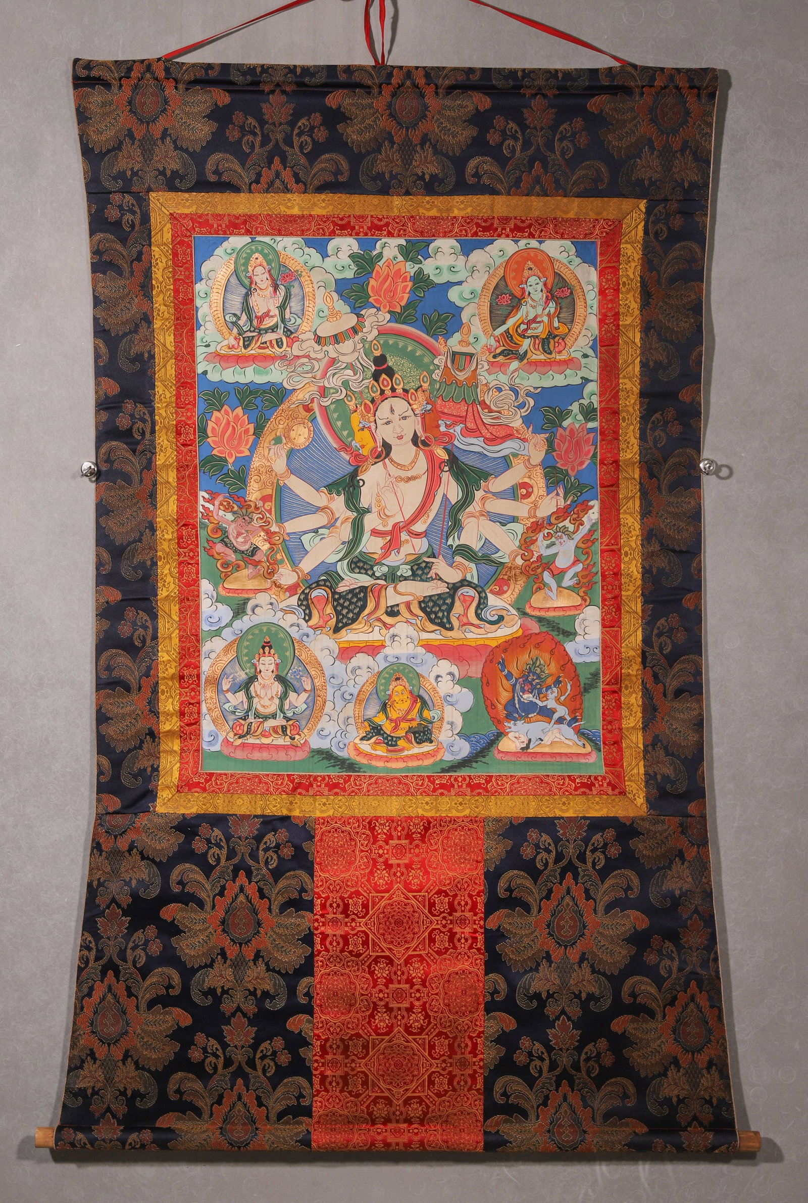 A Sitatapatra Thangka, Qing Dynasty: L 78cm (30.71 in); W 58cm (22.83 in)This Qing Dynasty thangka depicts Sitatapatra, the main deity, with three faces and eight arms, surrounded by other protectors and deities. It features bright color
