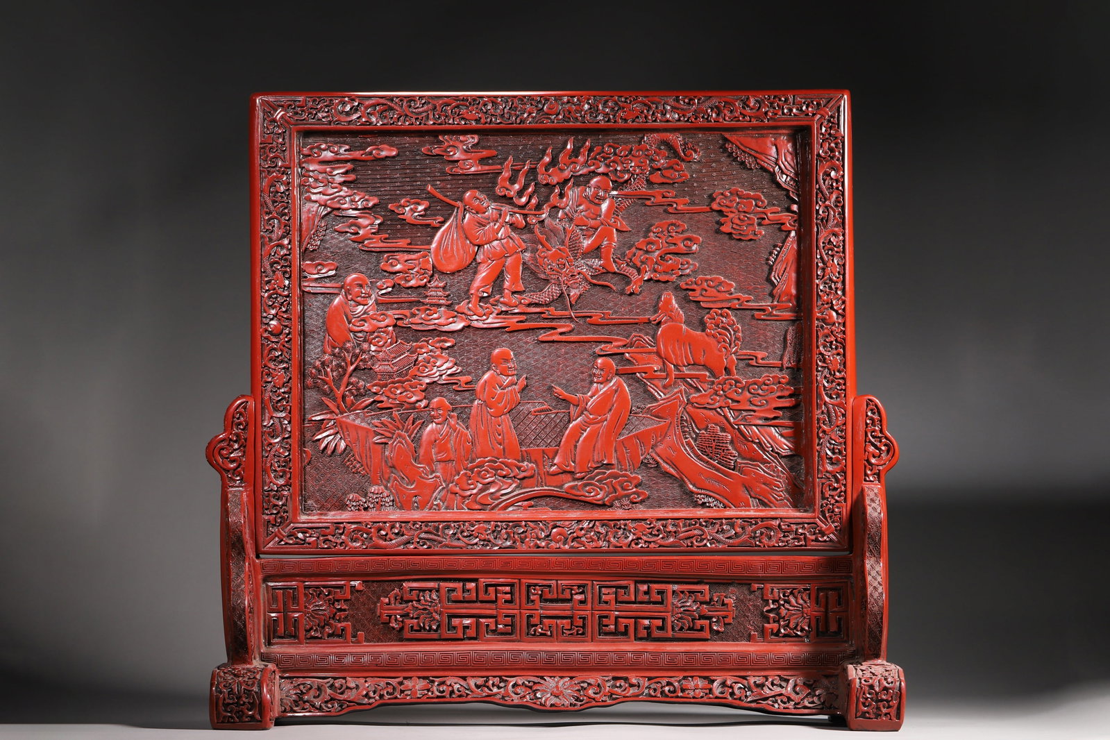 A Cinnabar Lacquer Carved Table Screen with Eighteen Arhats Design, Marked "Da Qing Qian Long Nian (1 of 11)