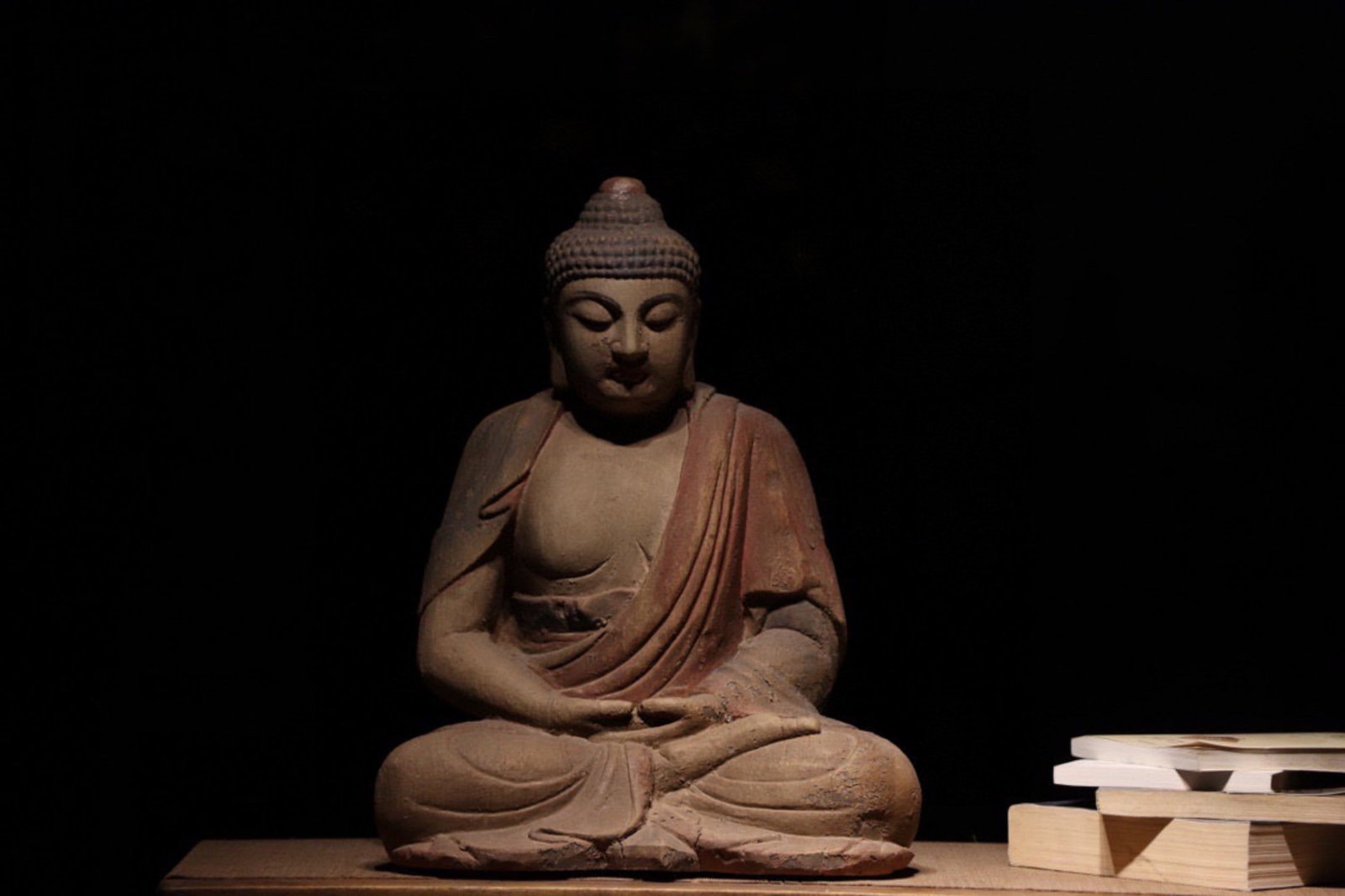 A Polychrome Wood Figure of Seated Buddha Sakyamuni - Ming Dynasty: Height 45cm (17.72 in)This polychrome wood figure of the seated Buddha, carved from a single block of wood, dates to the Ming Dynasty. Seated in meditation, the Buddha has serene downcast eyes, neatly