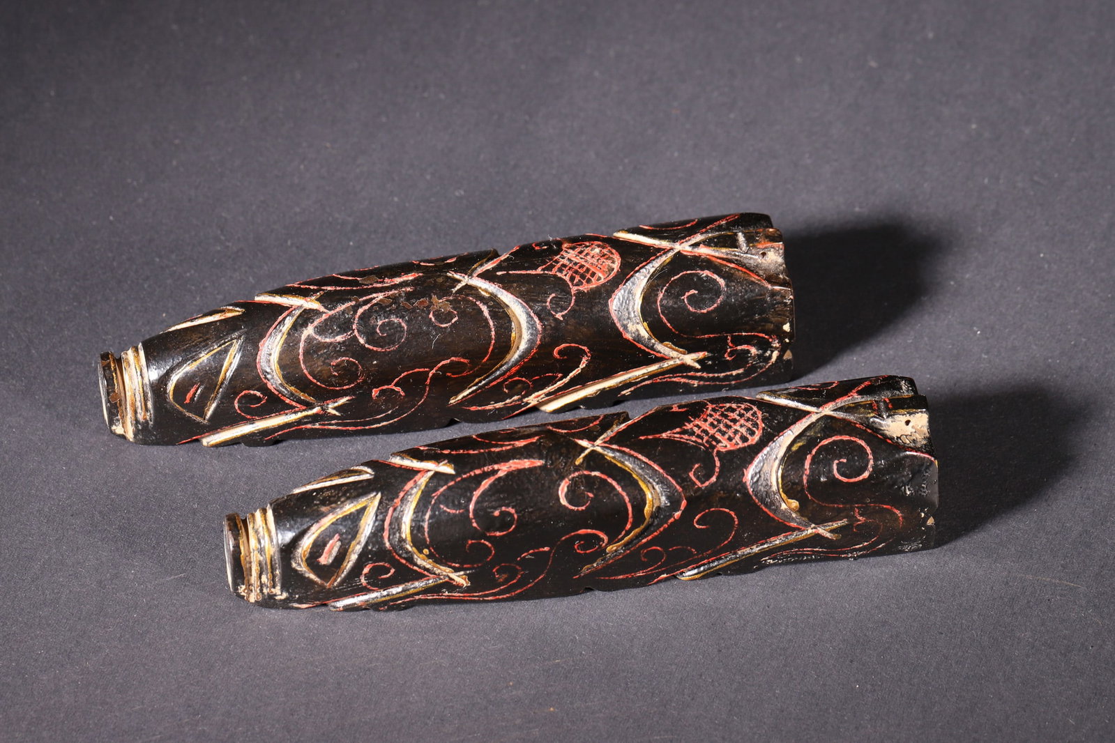 A Pair of Lacquered Jade Pig-Shaped Components with Gold and Color Inlaid Cloud Pattern - Han: Length 12.5cm (4.92in), Width 2.6cm (1.02in), Height 2.6cm (1.02in), Weight 391.0g (0.86lb)A pair of Han Dynasty lacquered jade pig-shaped components, decorated with gold and color inlaid cloud patter