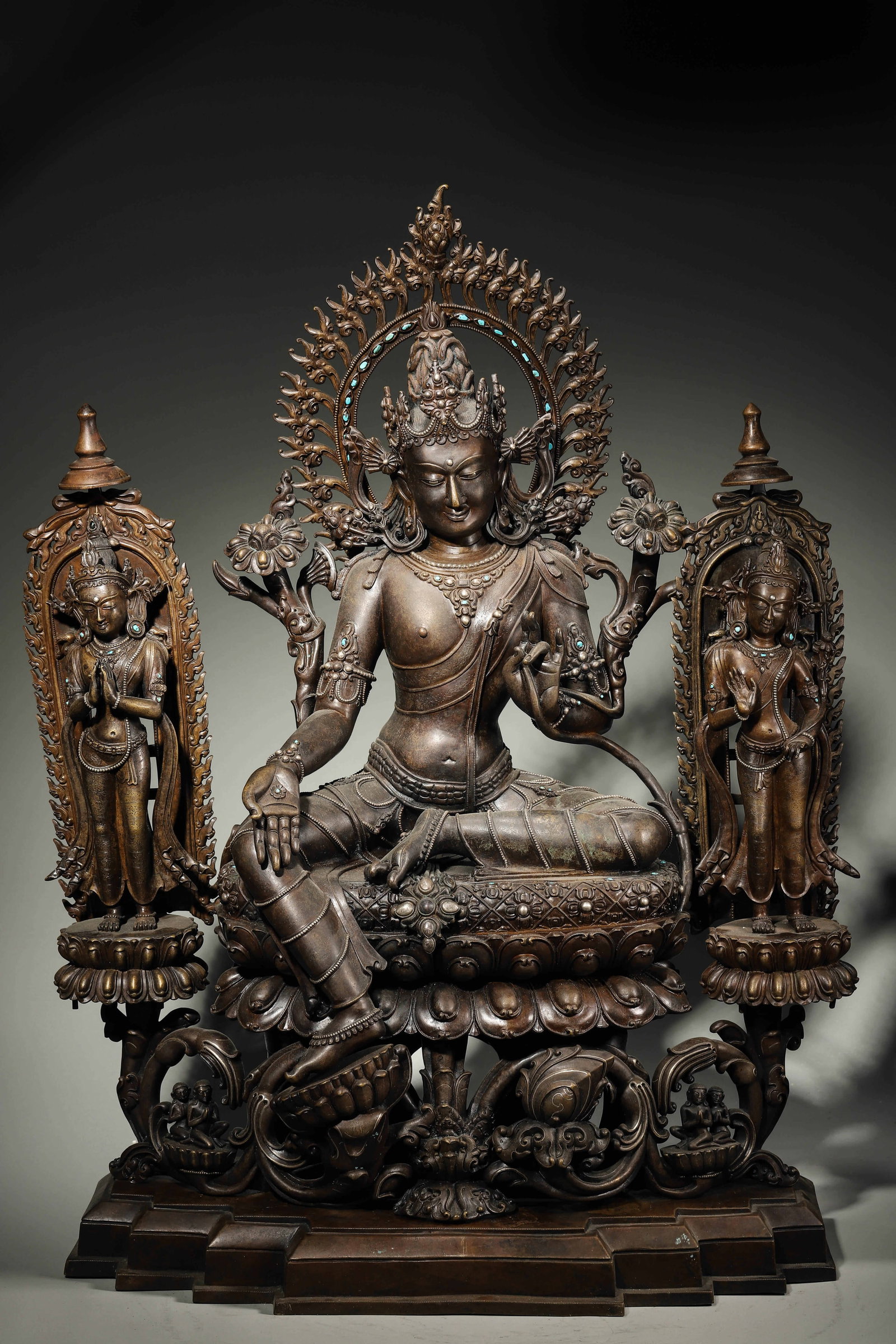 A High-Level Sino-Tibetan Alloy Copper Turquoise-Inlaid Statue of Green Tara, Pala Style, Song: L 54cm (21.26 in); W 25cm (9.84 in); H 62cm (24.41 in); Wt 33.2kg (73.19 lb)A Song Dynasty high-level alloy copper turquoise-inlaid Green Tara statue in Pala style, seated in lalitasana with two atten