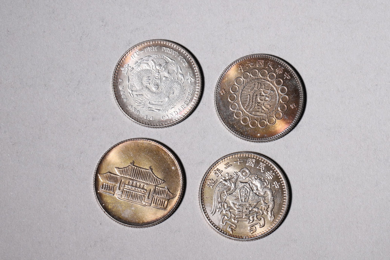 A Group of Ten Silver Coins with Dragon and Building Designs - 4