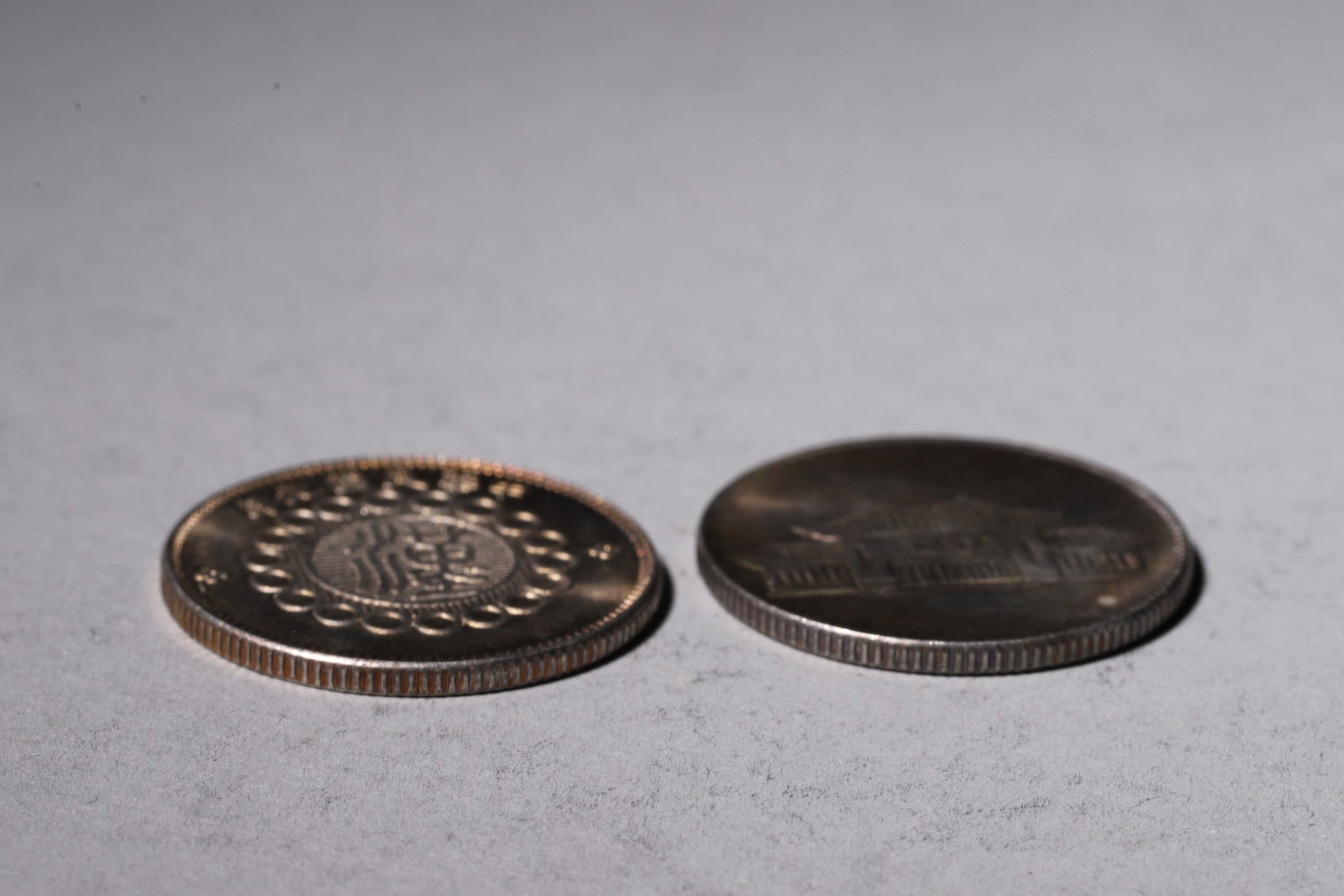 A Group of Ten Silver Coins with Dragon and Building Designs - 9