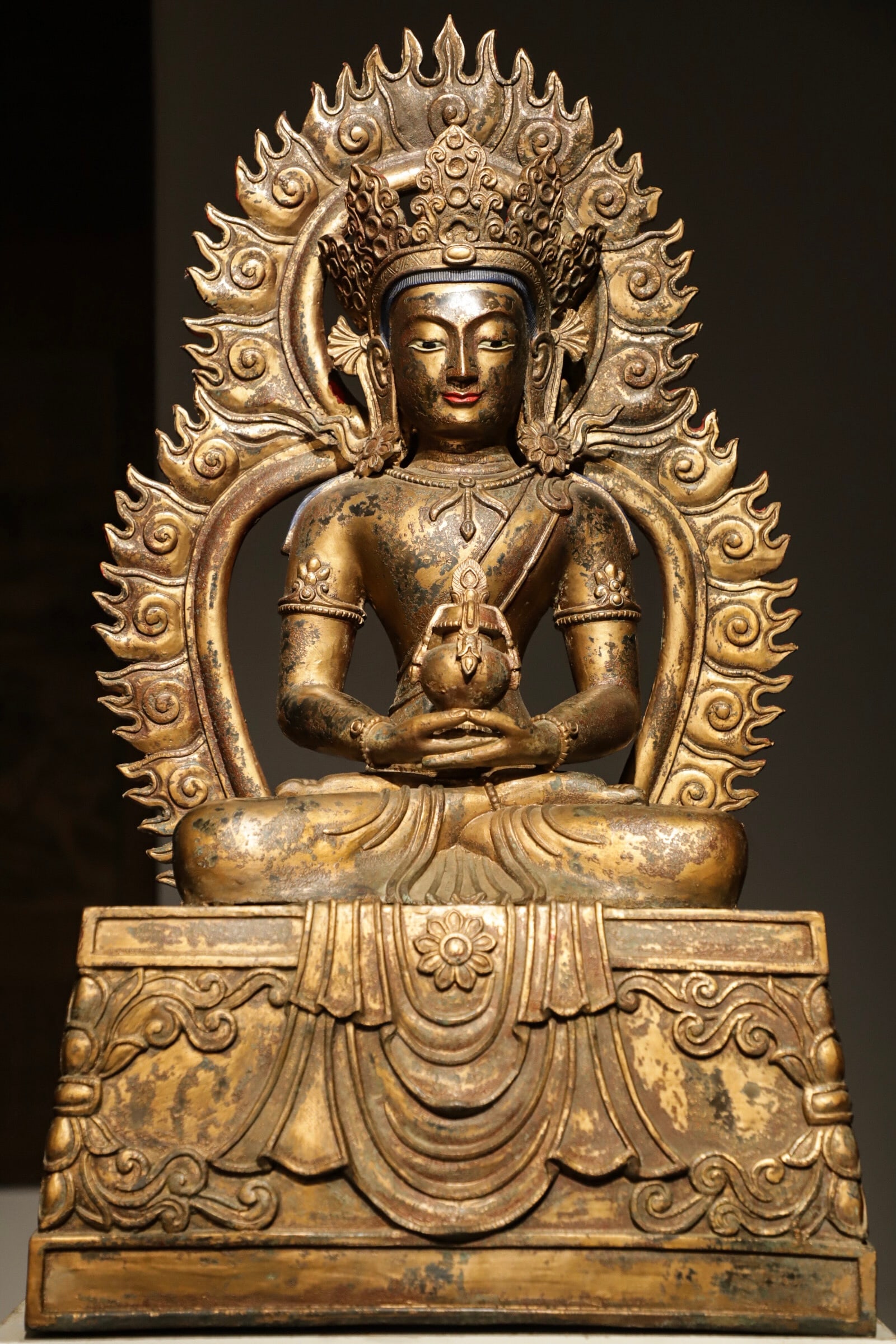 A Gilt Bronze Statue of Amitayus Buddha, Qing Dynasty: Height 70cm (27.56 in); Length 40cm (15.75 in); Width 28cm (11.02 in); Net Weight 40jin (44.09 lb)A gilt bronze statue of Amitayus Buddha from the Qing Dynasty. With a serene expression and exquisite 