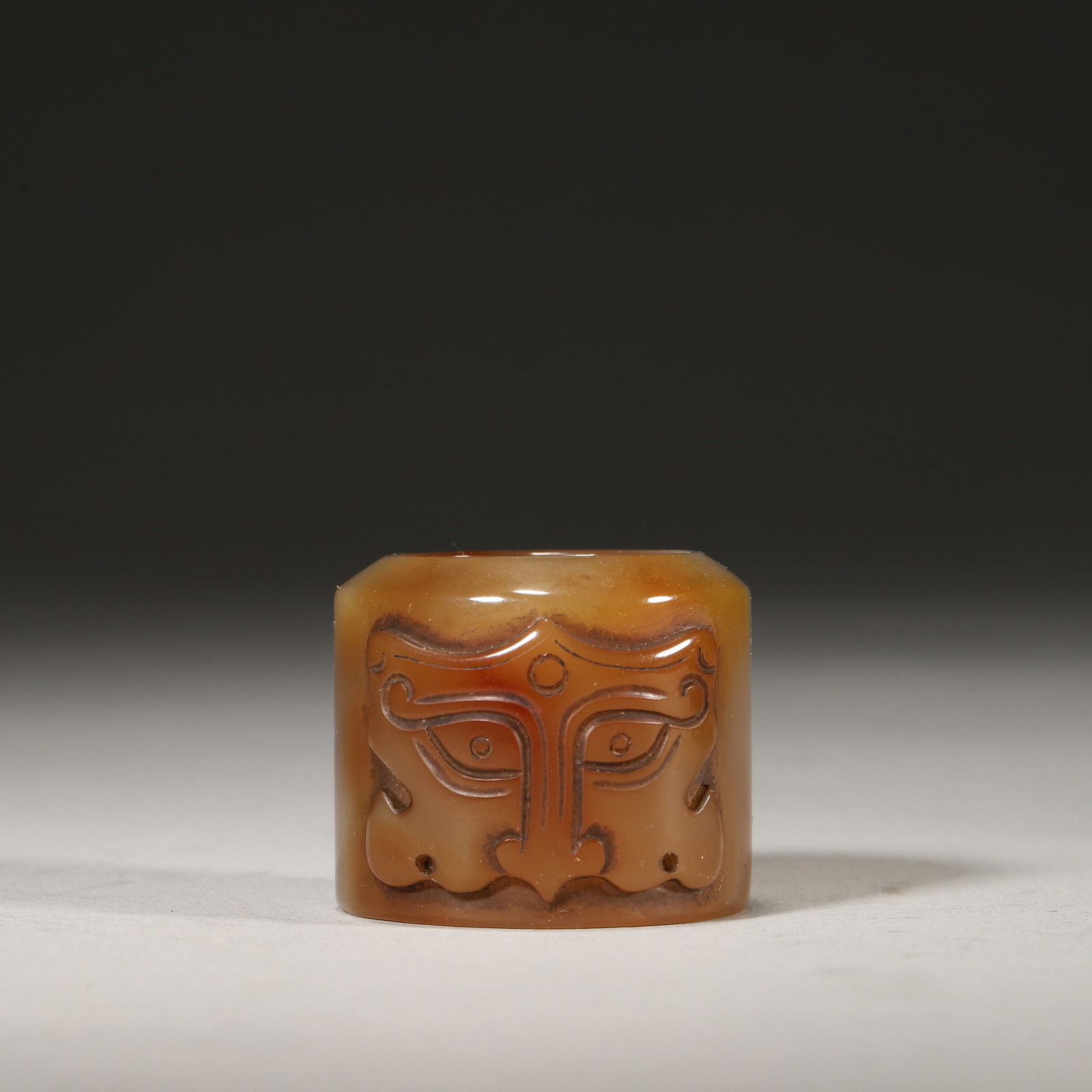 An Agate Beast Mask Archer's Ring and a Green Glass Archer's Ring Case with "Qianlong Nian Zhi - 2