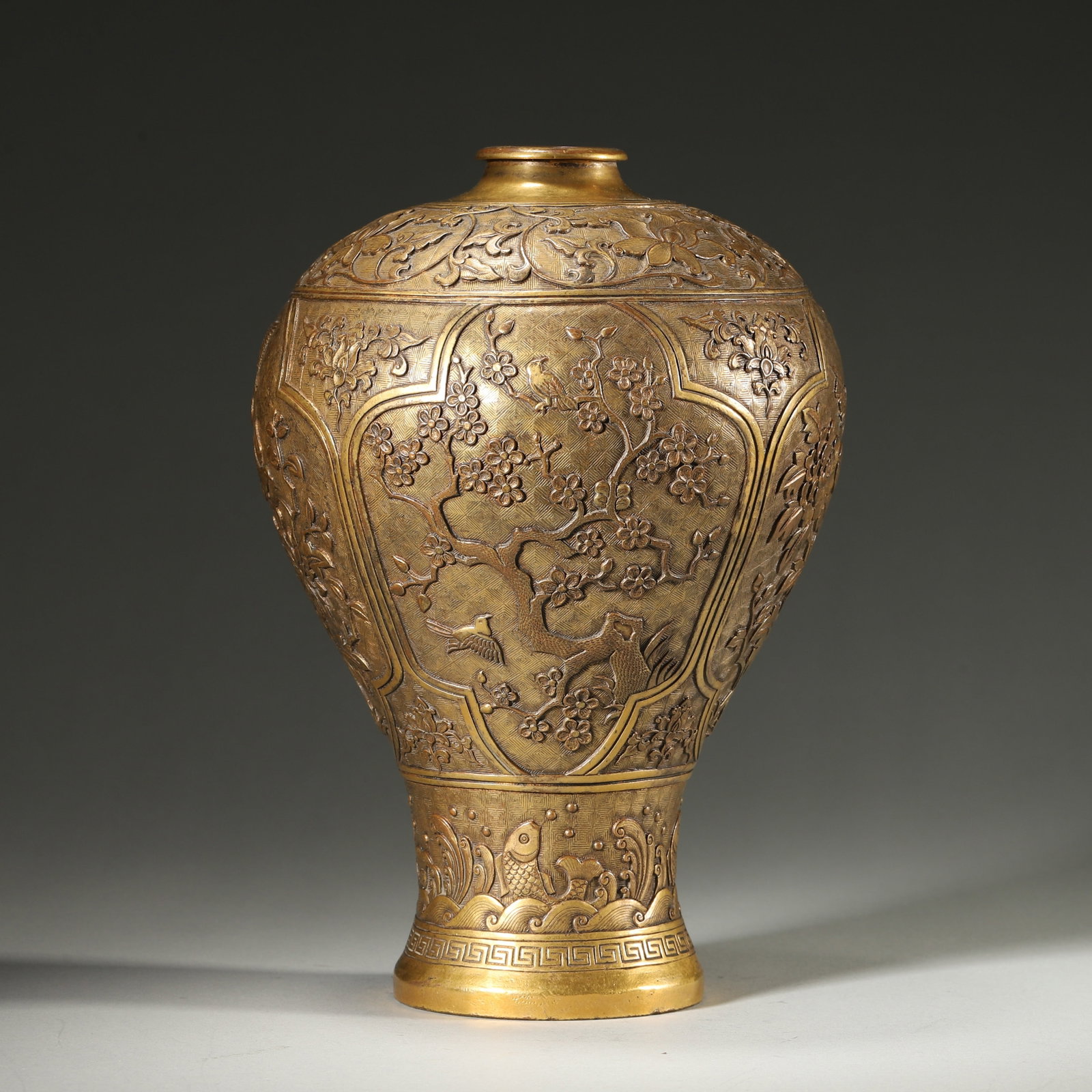A Gilt Bronze Prunus Vase with Floral and Bird Panels, Qing Dynasty: D 15cm (5.91 in); H 20cm (7.87 in); Wt 975g (2.15 lb)A Qing Dynasty gilt bronze prunus vase, decorated with carved floral and bird motifs in panels on a brocade ground. With mellow gilding and the "Ch