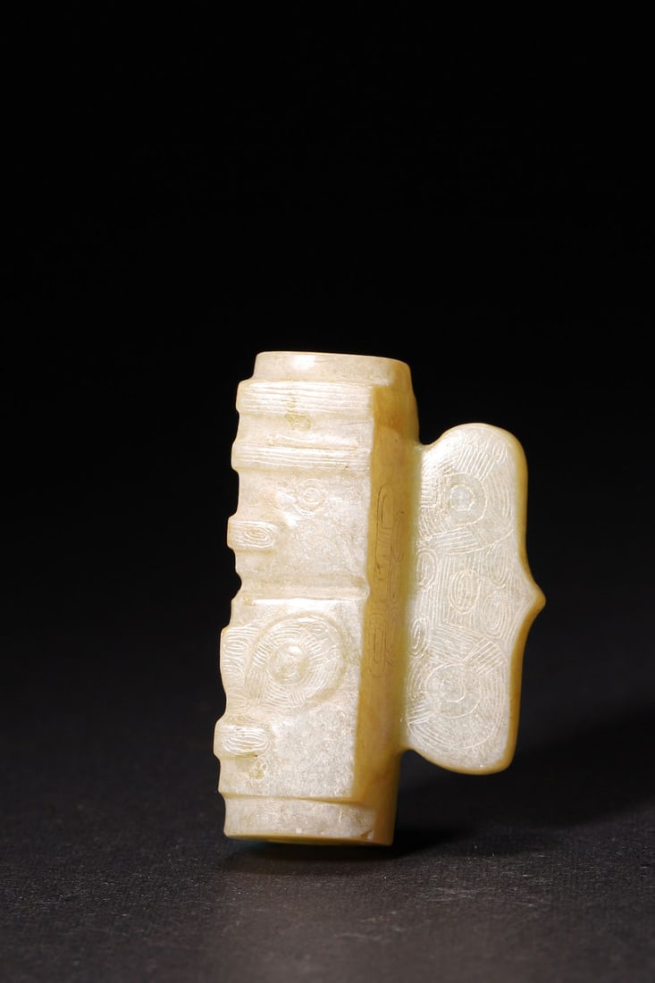 A Liangzhu Culture Jade Tube with Deity and Beast Pattern: Length 2.5cm (0.98in), Width 1.3cm (0.51in), Height 4.0cm (1.57in), Weight 23.0g (0.05lb)A Liangzhu Culture jade tube, carved with deity and beast patterns. With natural inclusions, it reflects the sa