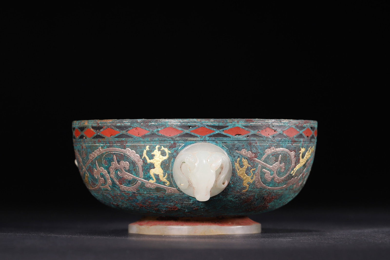 A Gold and Silver Inlaid Bronze Bowl with Jade and Red Inlay - Warring States Period: Diameter 11.5cm (4.53in), Height 5.0cm (1.97in), Weight 295.0g (0.65lb)This Warring States bronze bowl is elaborately decorated with gold and silver inlay, red patterns and jade ornaments. It is inlai