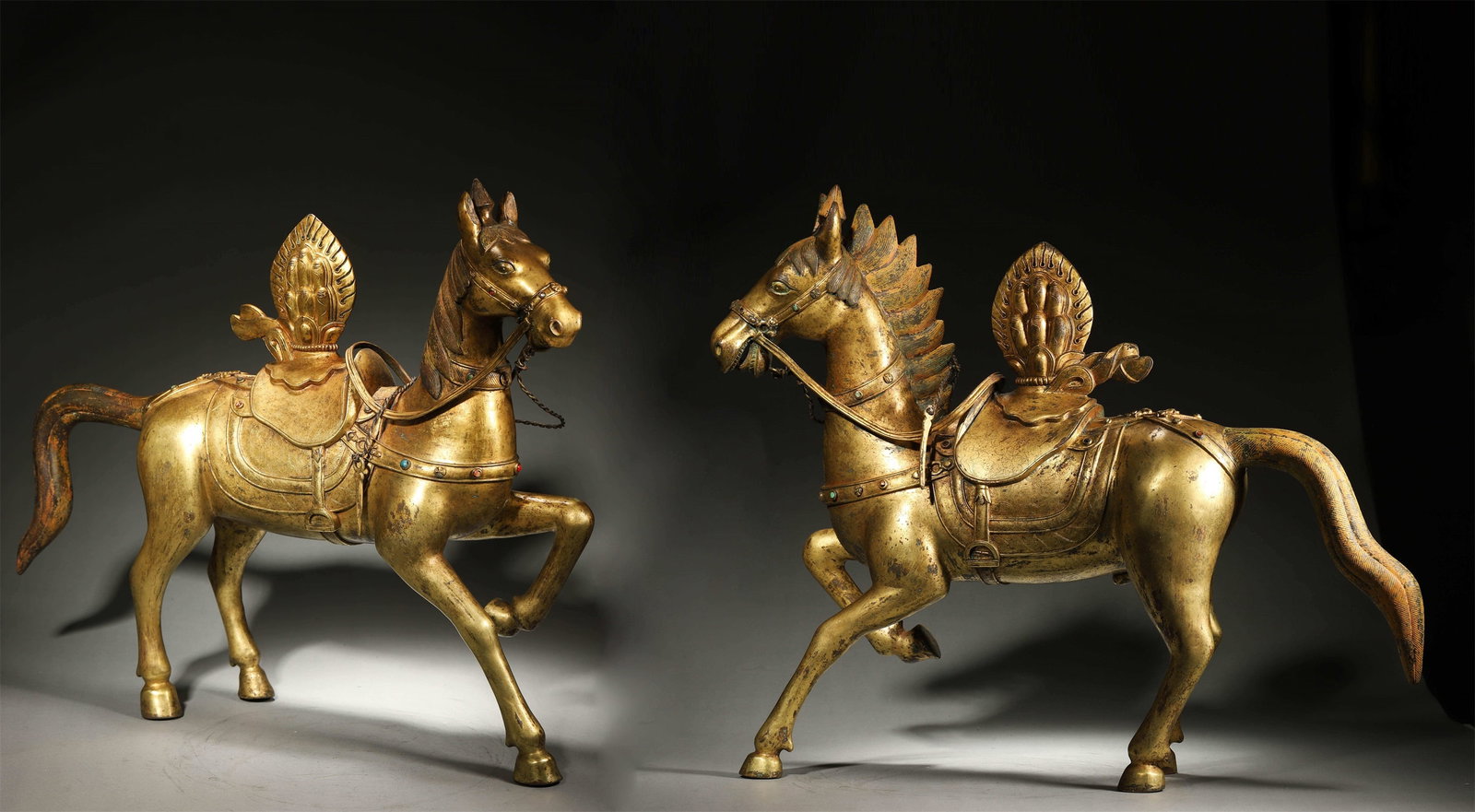 A Pair of Gilt-Bronze Turquoise-Inlaid Tibetan Temple Offering Horses, Qing Dynasty: L 57cm (22.44 in); W 14cm (5.51 in); H 47cm (18.5 in); Wt 20kg (44.09 lb)A pair of gilt-bronze turquoise-inlaid offering horses for Tibetan temples, Qing Dynasty, with one hoof raised, carrying a wish