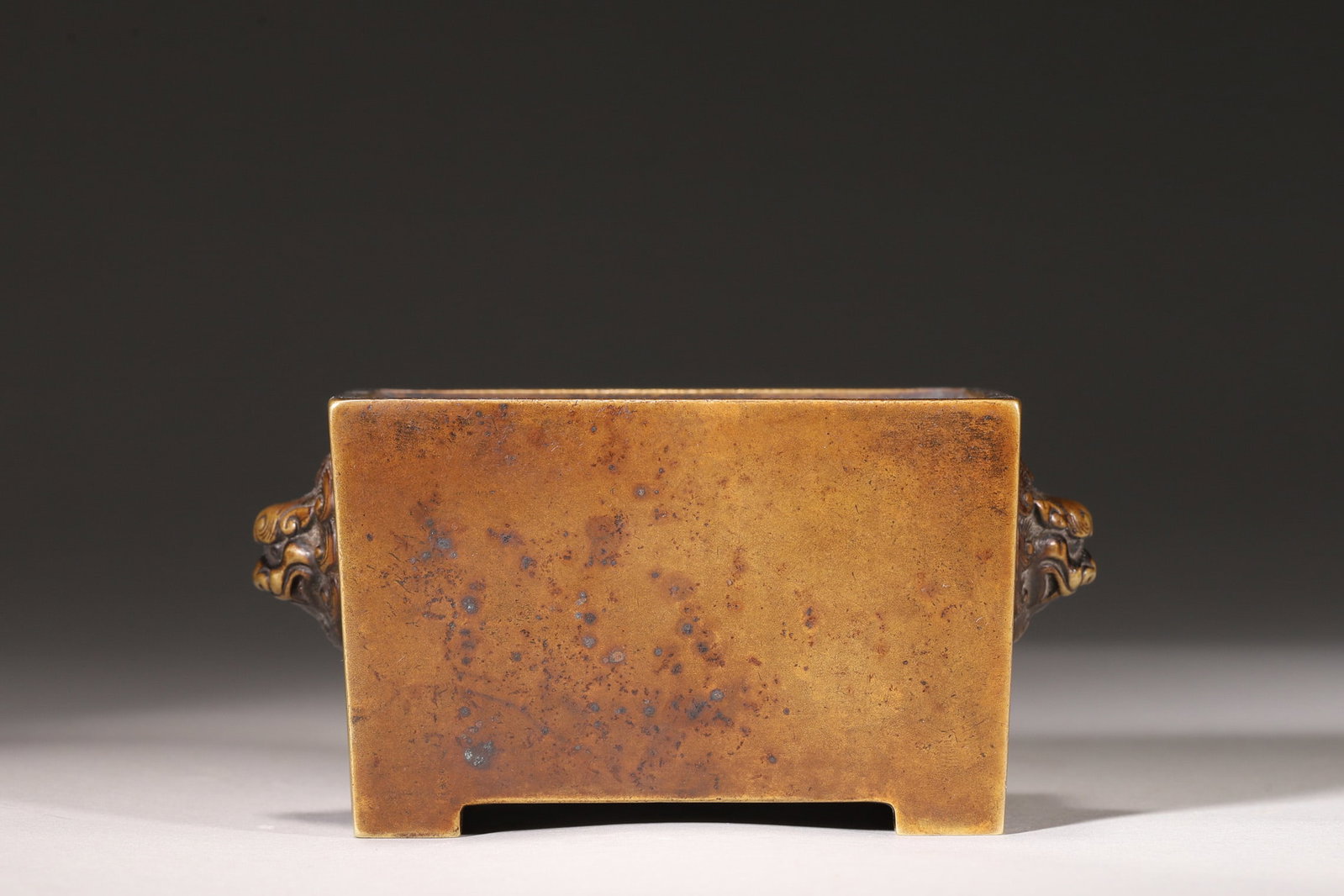 A Bronze Horse-Trough Incense Burner with Lion Handles, Qing Dynasty: Length 11.0cm (4.33in), Width 7.0cm (2.76in), Height 5.5cm (2.17in), Weight 656.0g (1.45lb)A bronze horse-trough incense burner with lion handles, dating to the Qing Dynasty. Cast from refined bronze,