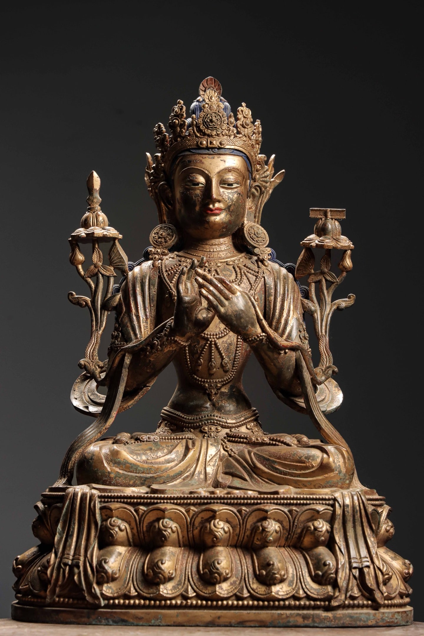 A Gilt Copper Figure of Manjushri, Qing Dynasty: Weight 32.5jin (35.83 lb); Height 61cm (24.02 in); Width 41.5cm (16.34 in); Thickness 28cm (11.02 in)A gilt copper figure of Manjushri from the Qing Dynasty, seated on a lotus throne with serene featu