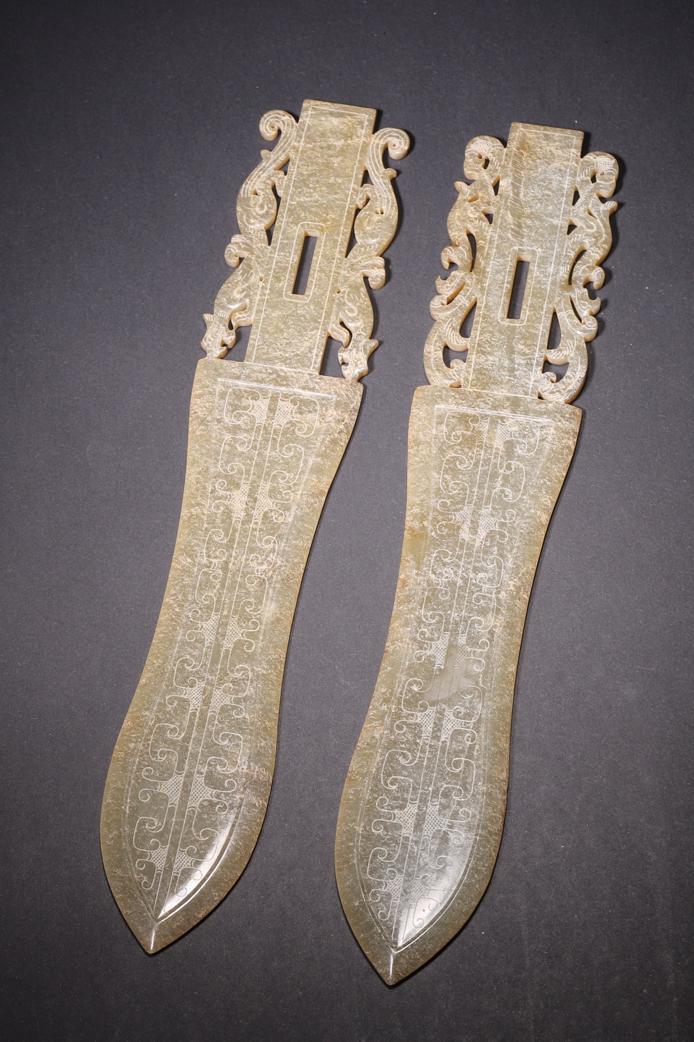 A Pair of Ancient Jade Ge with Dragon and Phoenix Motif - Han Dynasty: Length 24.0cm (9.45in), Width 4.5cm (1.77in), Weight 208.0g (0.46lb)This pair of jade ge is elaborately carved from ancient jade, featuring dragon-and-phoenix motifs and auspicious patterns. With natu