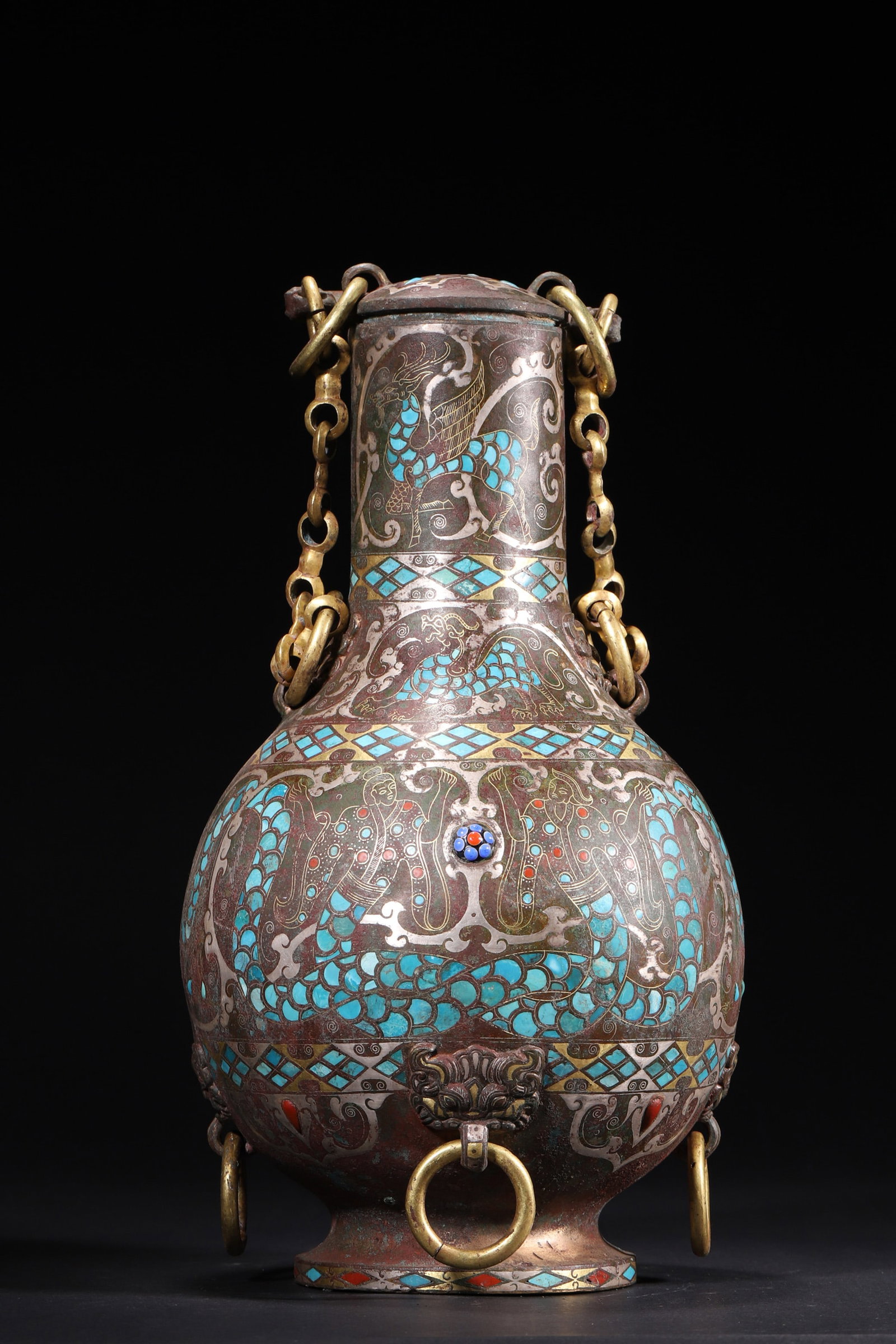 A Gold and Silver Inlaid Bronze Lidded Pot with Turquoise Inlay and Bail Handle - Warring States: Diameter 17.0cm (6.69in), Height 30.0cm (11.81in), Weight 2722.0g (6.0lb)This Warring States bronze pot is decorated with gold and silver inlaid dragon and phoenix patterns, and turquoise inlay. It ha
