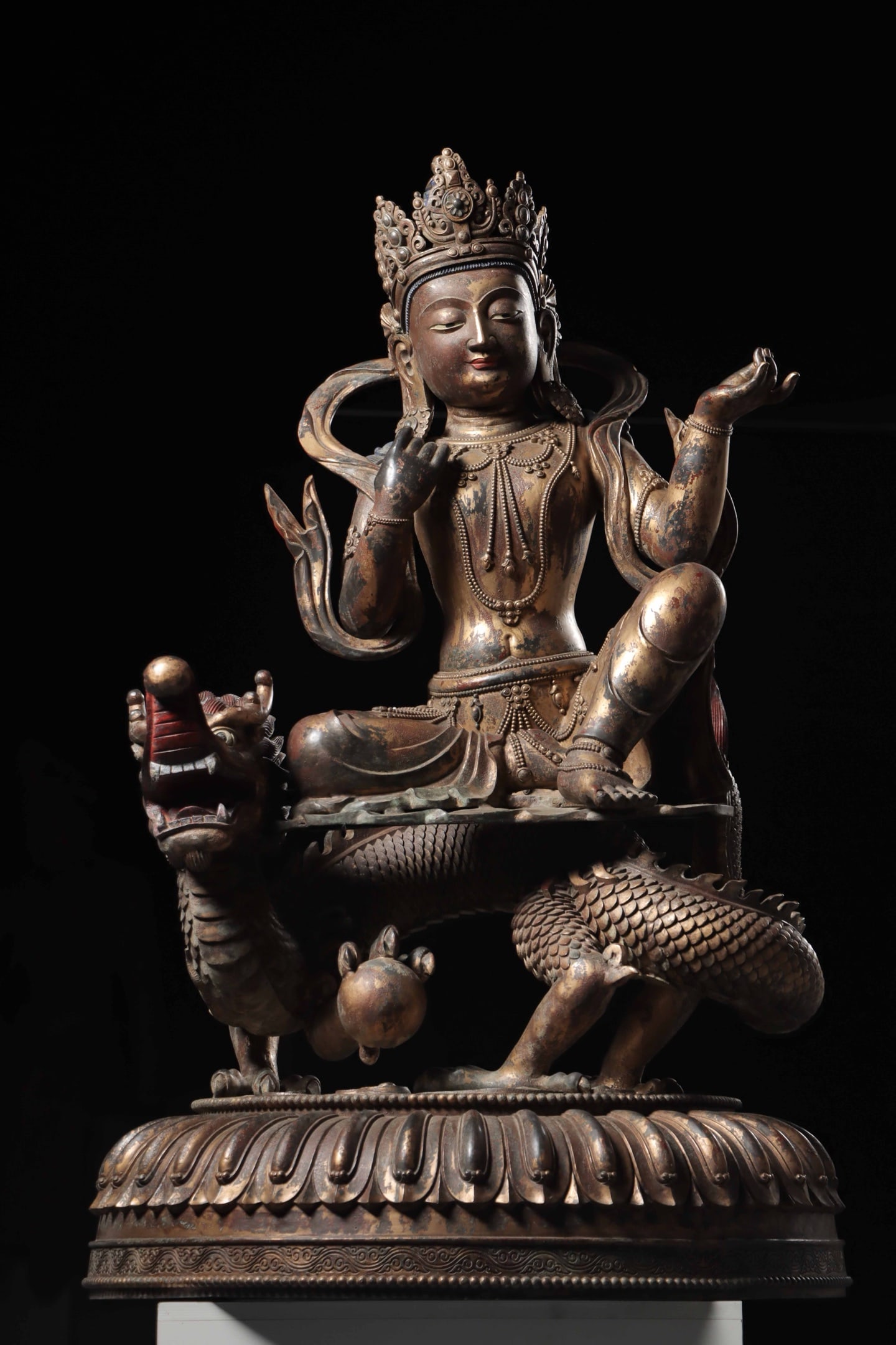 A Gilt Bronze Statue of Avalokiteshvara Riding a Dragon, Qing Dynasty: Net Weight 164.2jin (181 lb); Height 110cm (43.31 in)A gilt bronze statue of Avalokiteshvara riding a dragon from the Qing Dynasty. The Bodhisattva sits serenely with a compassionate expression, adorn