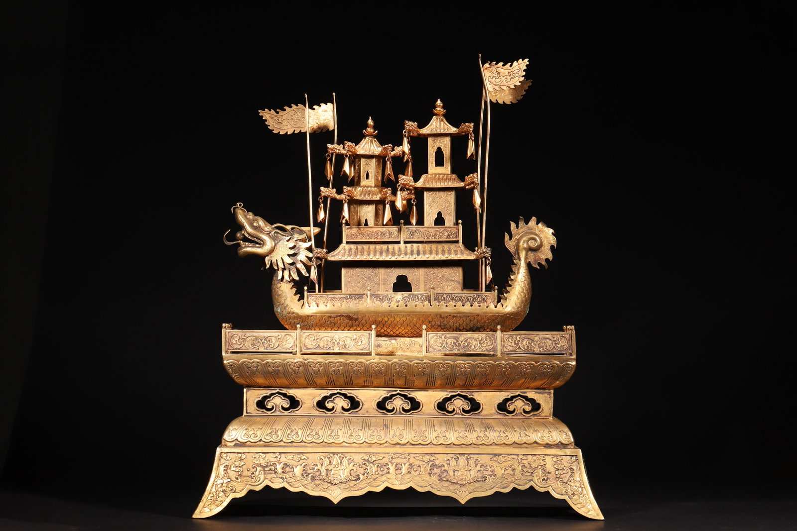 A Gilt Bronze Dragon Boat Ornament (Qing Dynasty): Length 40.0cm (15.75in), Width 17.0cm (6.69in), Height 48.0cm (18.9in), Weight 6838.0g (15.08lb)This Qing Dynasty ornament is crafted from gilt bronze. It features an elaborate dragon boat with pavili