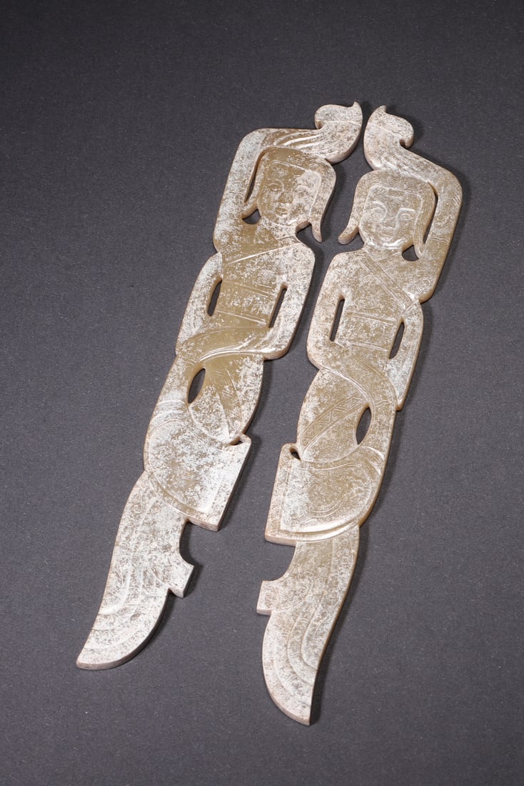 A Pair of Ancient Jade Dancer Pendants - Han Dynasty: Length 14.5cm (5.71in), Width 2.5cm (0.98in), Weight 71.0g (0.16lb)This pair of jade dancer pendants is elaborately carved from ancient jade, featuring vivid dancing figures with elegant flowing robes