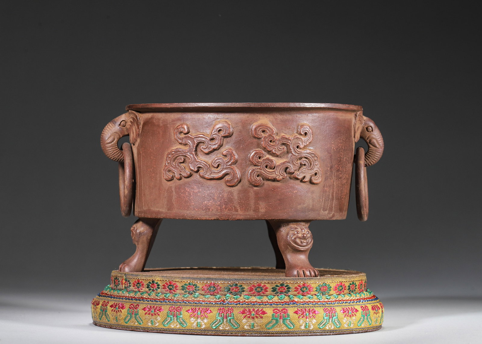 Late Qing to Early Republic of China - Zisha Tripod Censer with Elephant-Head Handles, Made by Jiang: D 16.0 cm (D 6.3 in)This censer is crafted from zisha clay, supported by three beast feet. It features elephant-head handles with movable rings and carved dragon motifs on the exterior. The interior i