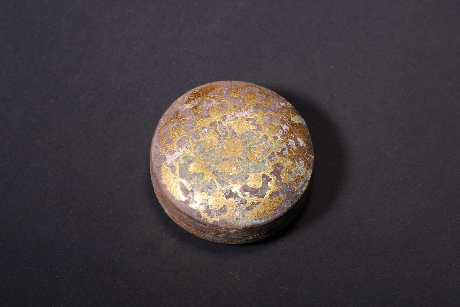 A Gilt Silver Round Box with Mandarin Duck Pattern, Tang Dynasty: Diameter 4.5cm (1.77in), Weight 12.0g (0.03lb)This is a Tang Dynasty gilt silver round box with mandarin duck pattern. With a fish roe ground, it features gilt engravings of mandarin ducks and lotus, 
