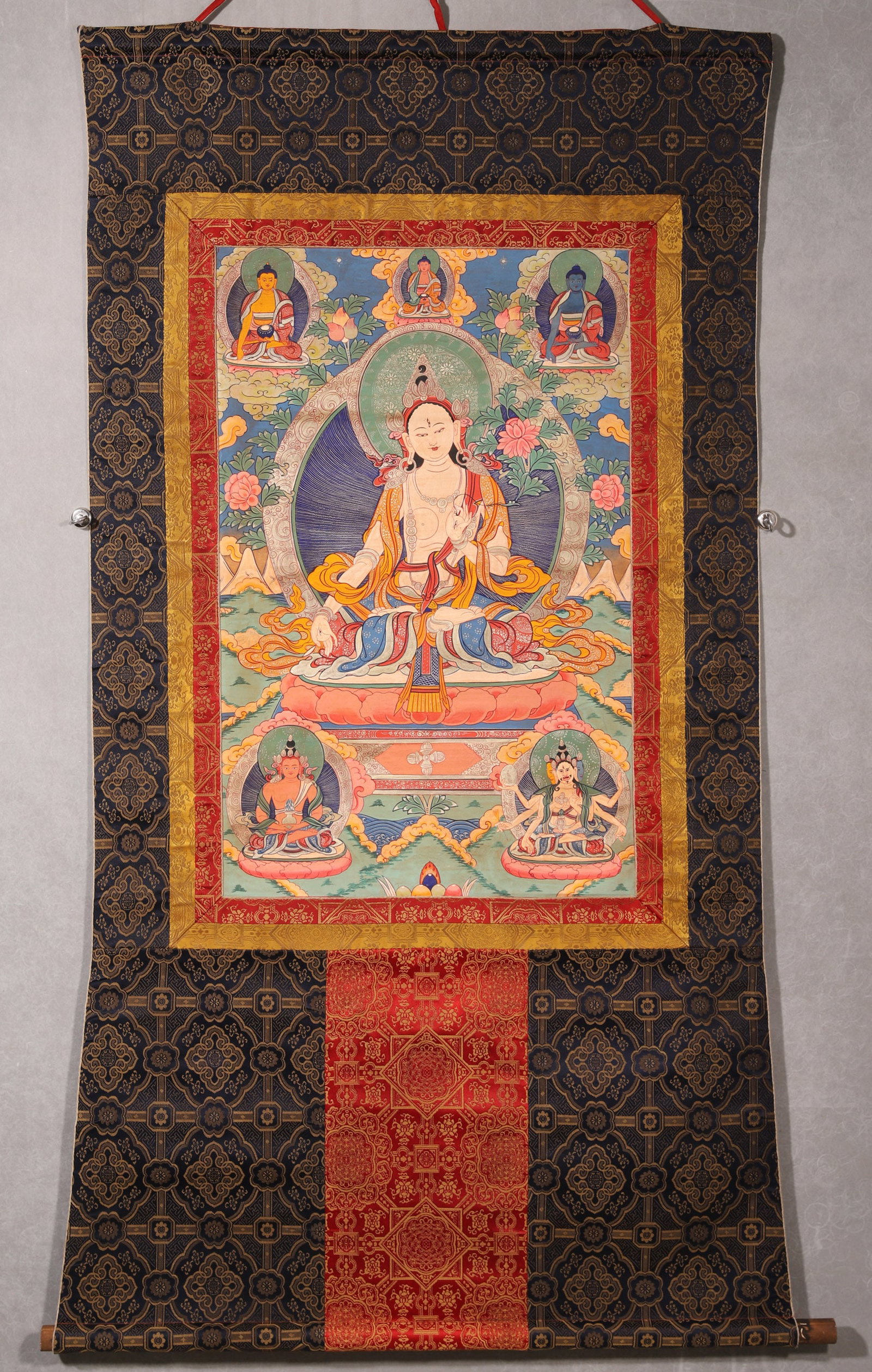 A White Tara Thangka, Qing Dynasty: L 76cm (29.92 in); W 48cm (18.9 in)This Qing Dynasty thangka depicts White Tara, the main deity, with the Three Buddhas above and other deities below. It features bright colors, smooth lines, and trad