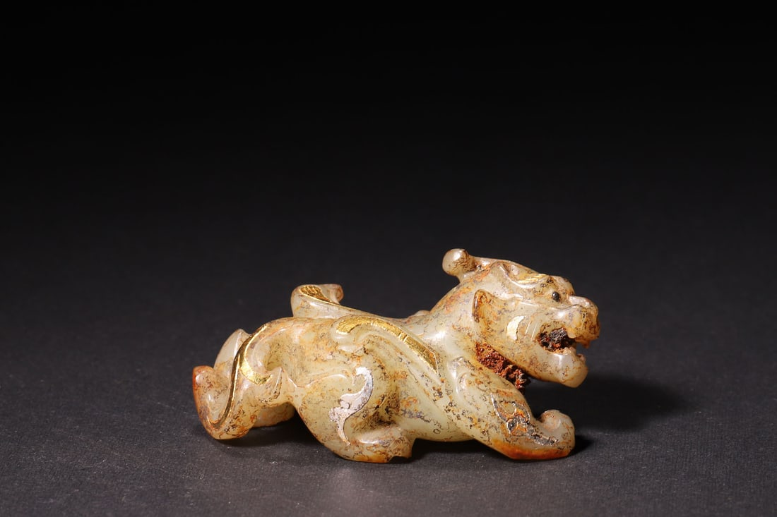 A Han Dynasty Hetian Jade Ornament with Gold/Silver Inlay: Length 5.6cm (2.2in), Width 2.7cm (1.06in), Height 2.8cm (1.1in), Weight 36.0g (0.08lb)A Han Dynasty Hetian jade ornament in the form of an auspicious beast, decorated with gold and silver inlaid patt