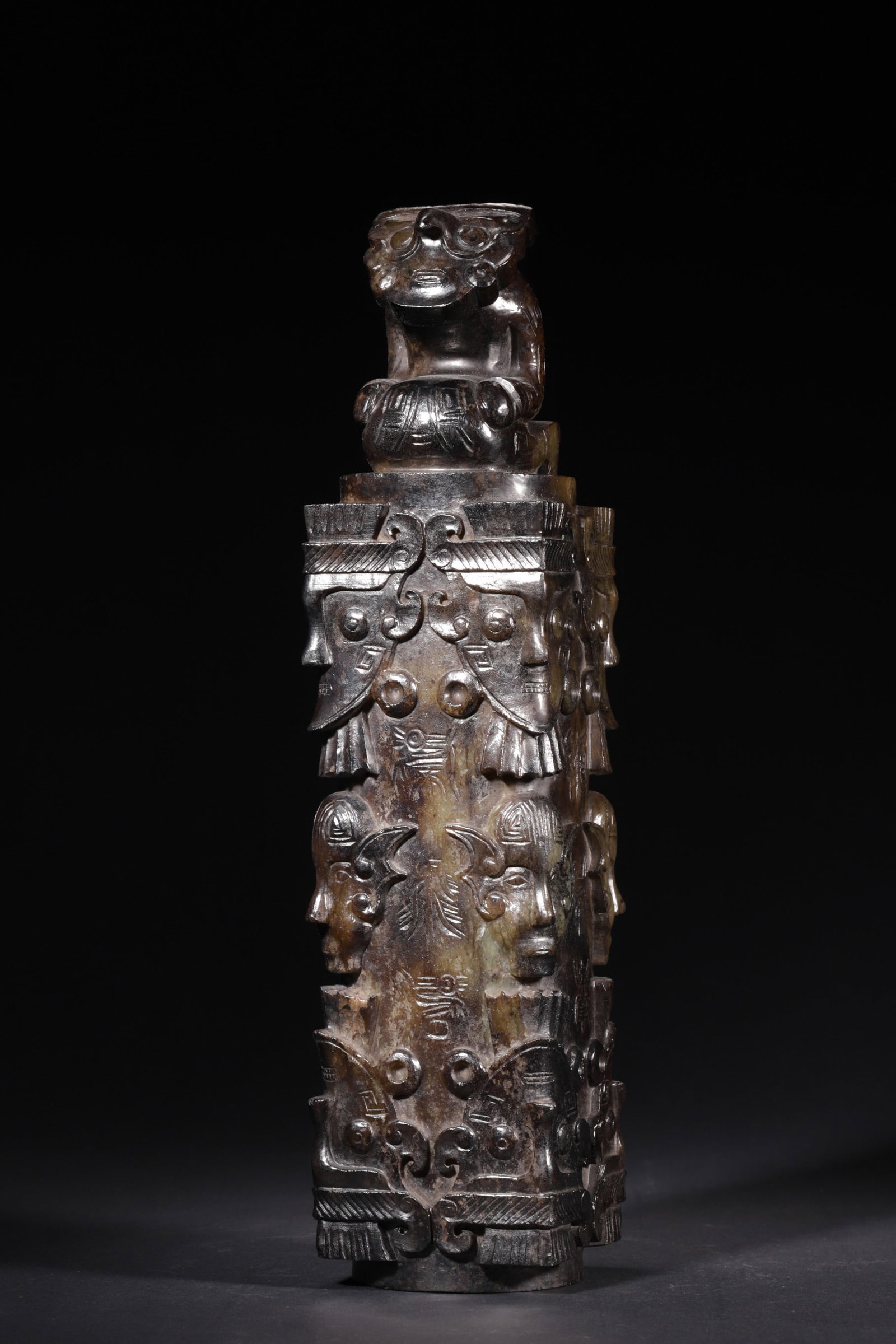 An Ancient Jade Cong-style Tube with Human Face Motifs: Length 8.0cm (3.15in), Width 8.0cm (3.15in), Height 34.0cm (13.39in), Weight 3589.0g (7.91lb)This high ancient jade tube is carved with elaborate human and beast face motifs, bearing inscriptions. The