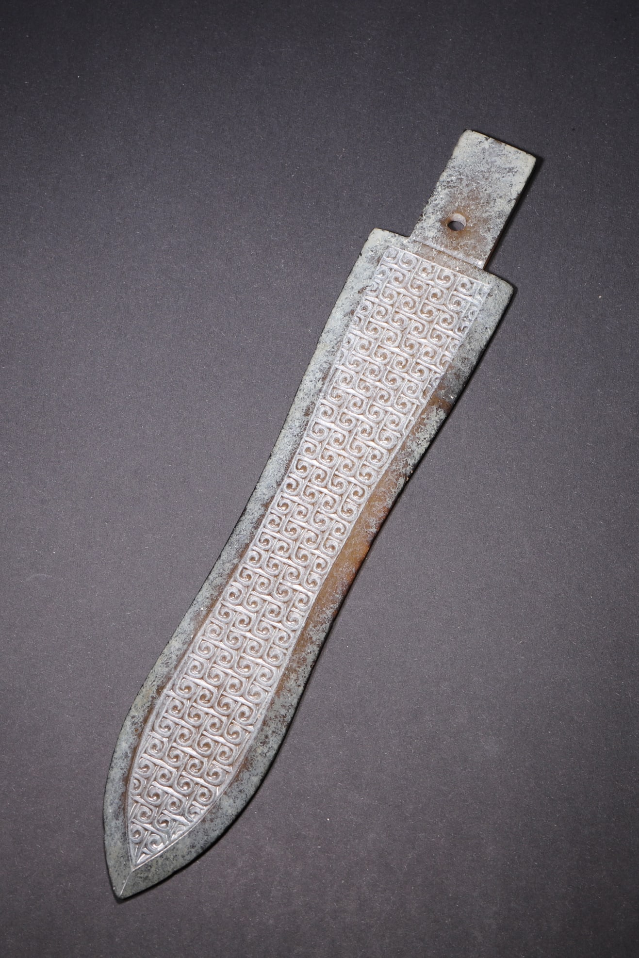 An Ancient Jade Ge with Whorl Pattern - Han Dynasty: Length 20.5cm (8.07in), Width 3.5cm (1.38in), Weight 59.0g (0.13lb)This jade ge is elaborately carved from ancient jade, featuring regular whorl patterns all over the body. With natural patina and exq