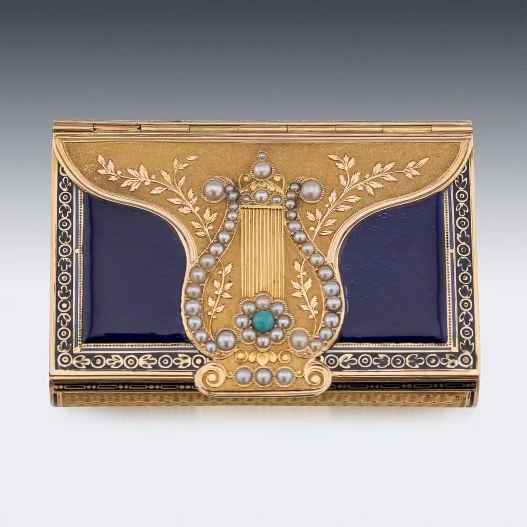 Early 19th Century Rare Swiss 18K Gold Enamel Music Box: Early 19th Century Rare Swiss 18K Gold Enamel Music BoxElegant and square in envelope shape, crafted with curved convex design on both front and reverse sides. The lid and base feature brushed metal s
