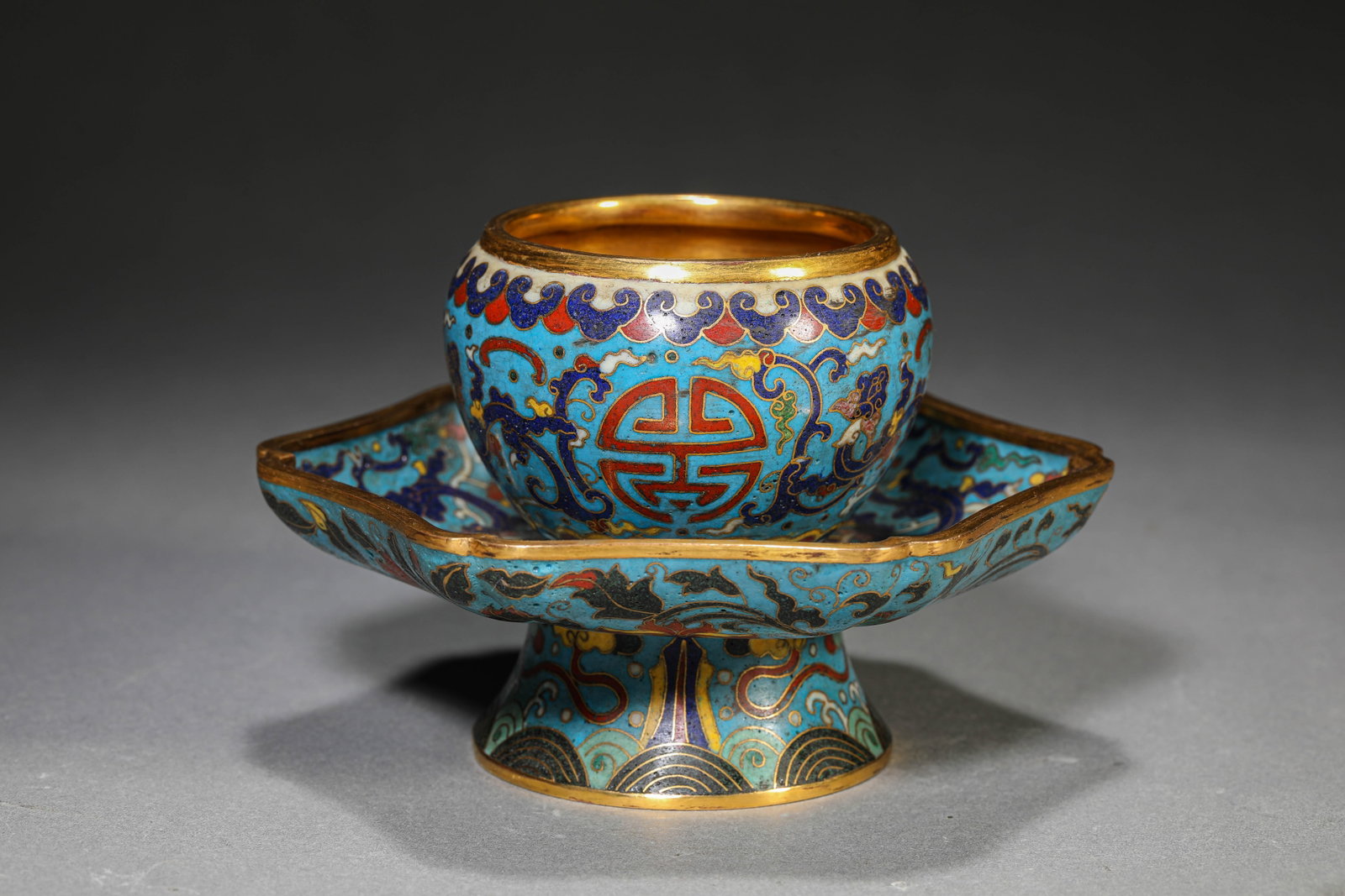 A Cloisonn?? Enamel ??Dragon?? Cup and Saucer: Dimensions: Weight: 674g. Length: 14.0 cm (5.51 in) x Width: 12.8 cm (5.04 in) x Height: 9.0 cm (3.54 in). All measurements are approximate.