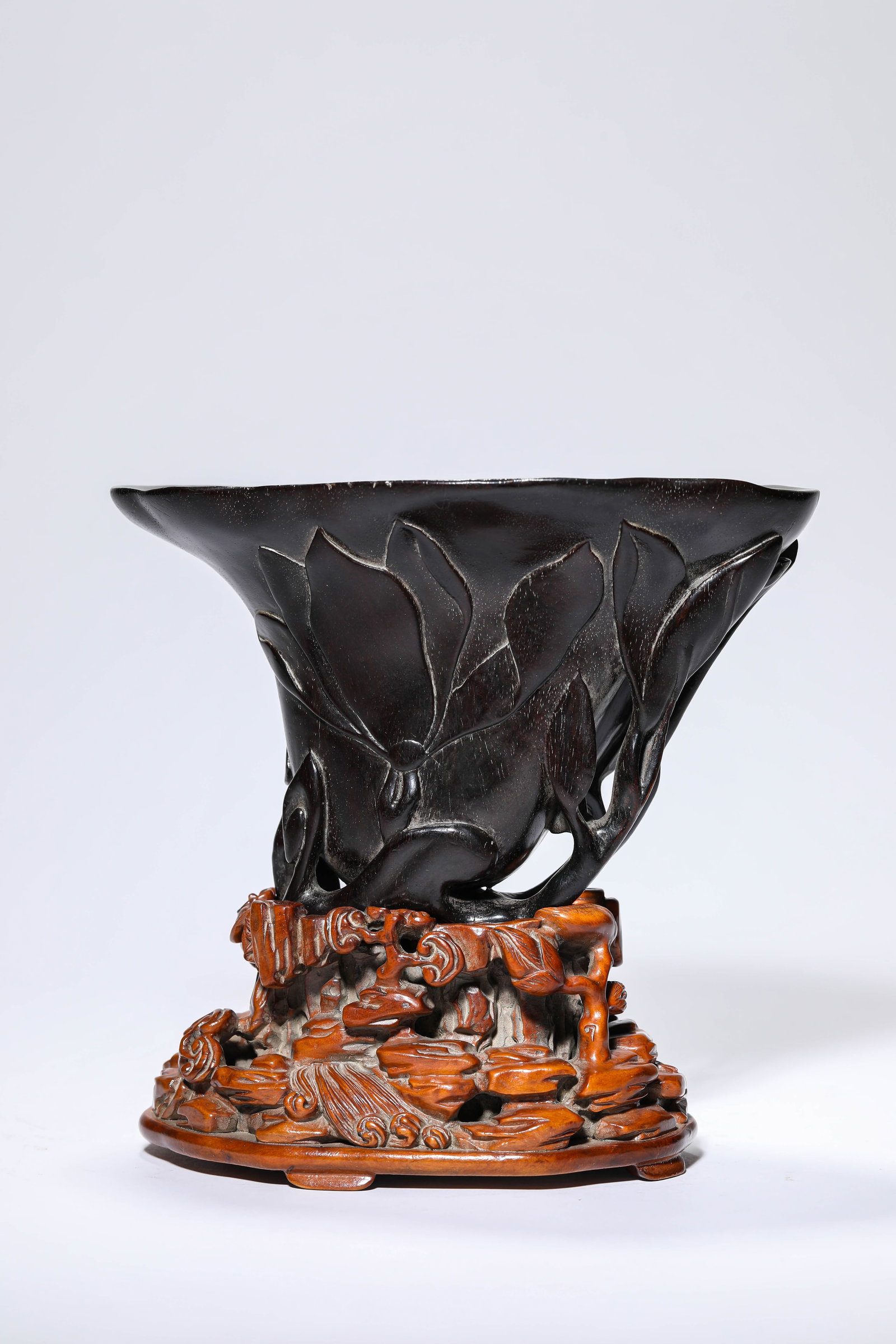 A Wood ??Carved Floral?? ??Rhinoceros Horn-Form?? Cup: Dimensions: Length: 17.7 cm (6.97 in) x Width: 10.7 cm (4.21 in) x Height: 11.0 cm (4.33 in). All measurements are approximate.