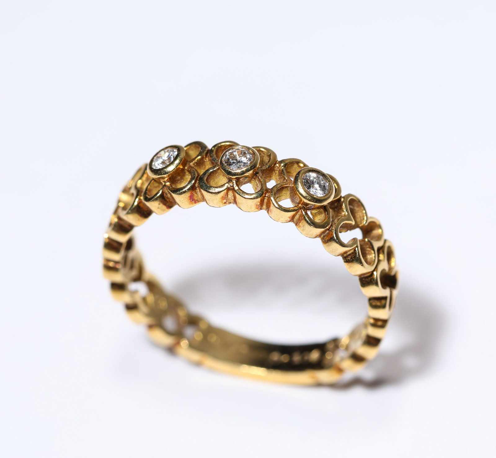 A Diamond and Gold Ring: Dimensions: Weight: 3g. Width: 1.6 cm (0.63 in). All measurements are approximate.