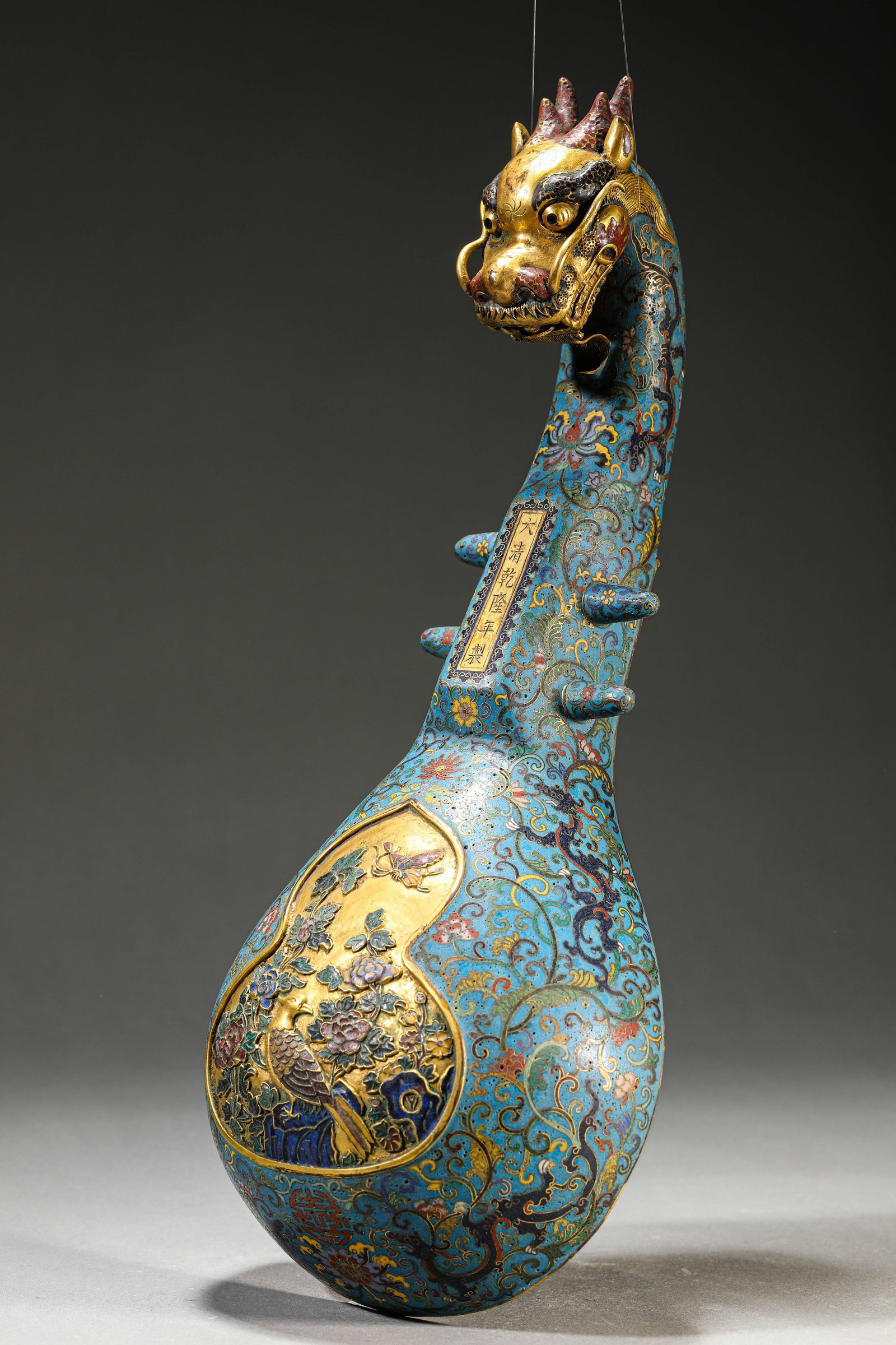 A Cloisonn?? Enamel ??Dragon-Head, Flowers and Birds?? ??Pipa-Form?? Ornament: Dimensions: Weight: 1539g. Width: 16.5 cm (6.50 in) x Height: 42.5 cm (16.73 in). All measurements are approximate.
