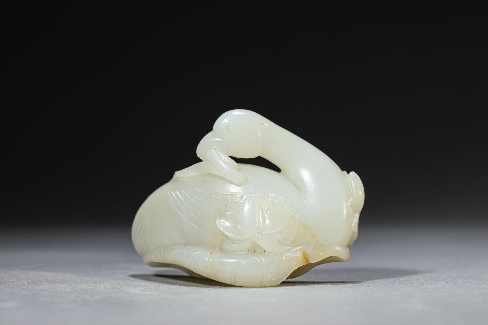 A Jade 'Goose' Ornament: Dimensions: Length: 7.4 cm (2.91 in) x Width: 2.9 cm (1.14 in) x Height: 5.2 cm (2.05 in). All measurements are approximate.