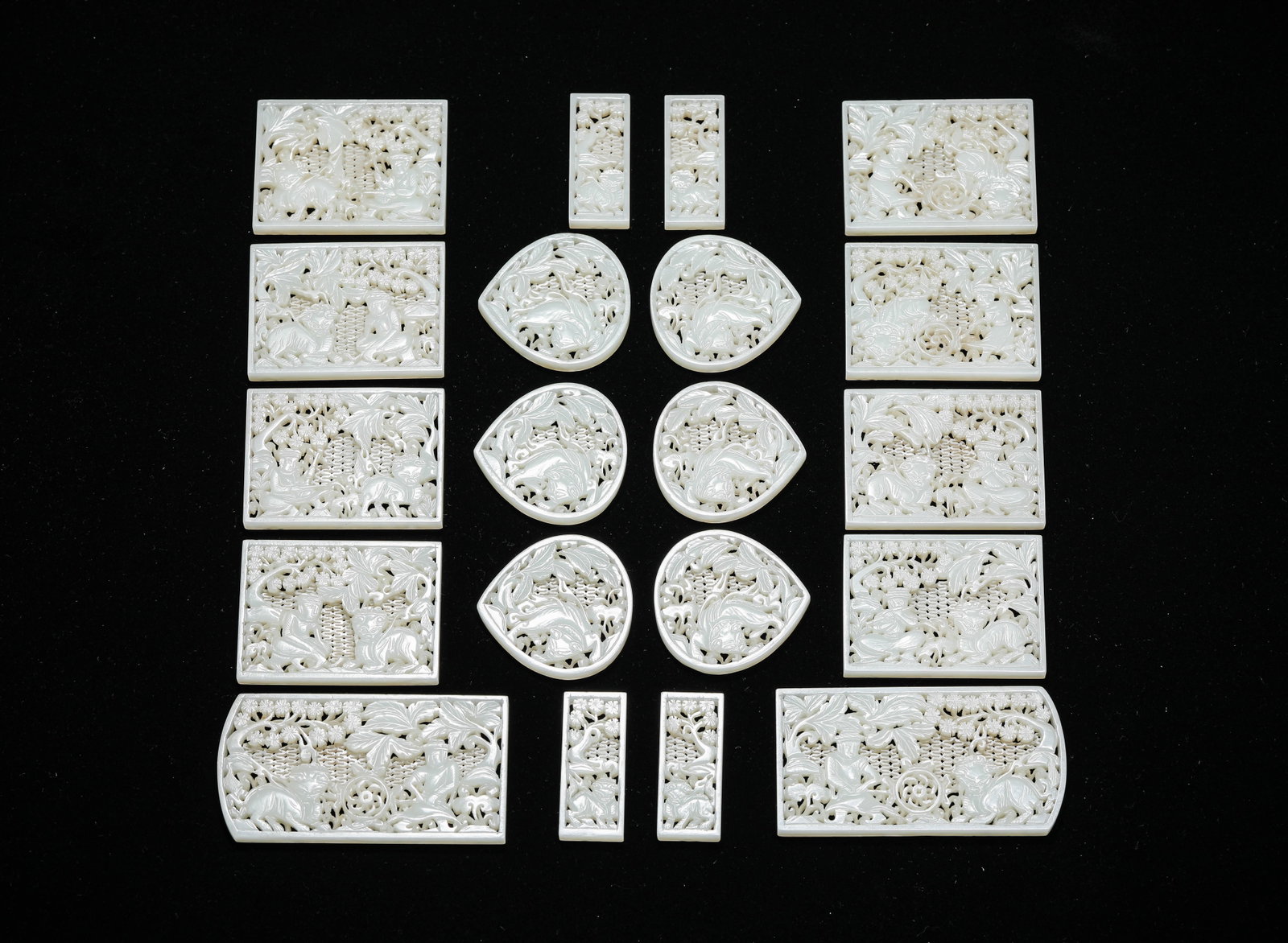 A Group of Jade Ornaments: Dimensions: Width: 9.3 cm (3.66 in) x Height: 4.8 cm (1.89 in). Width: 2.0 cm (0.79 in) x Height: 4.9 cm (1.93 in). All measurements are approximate.