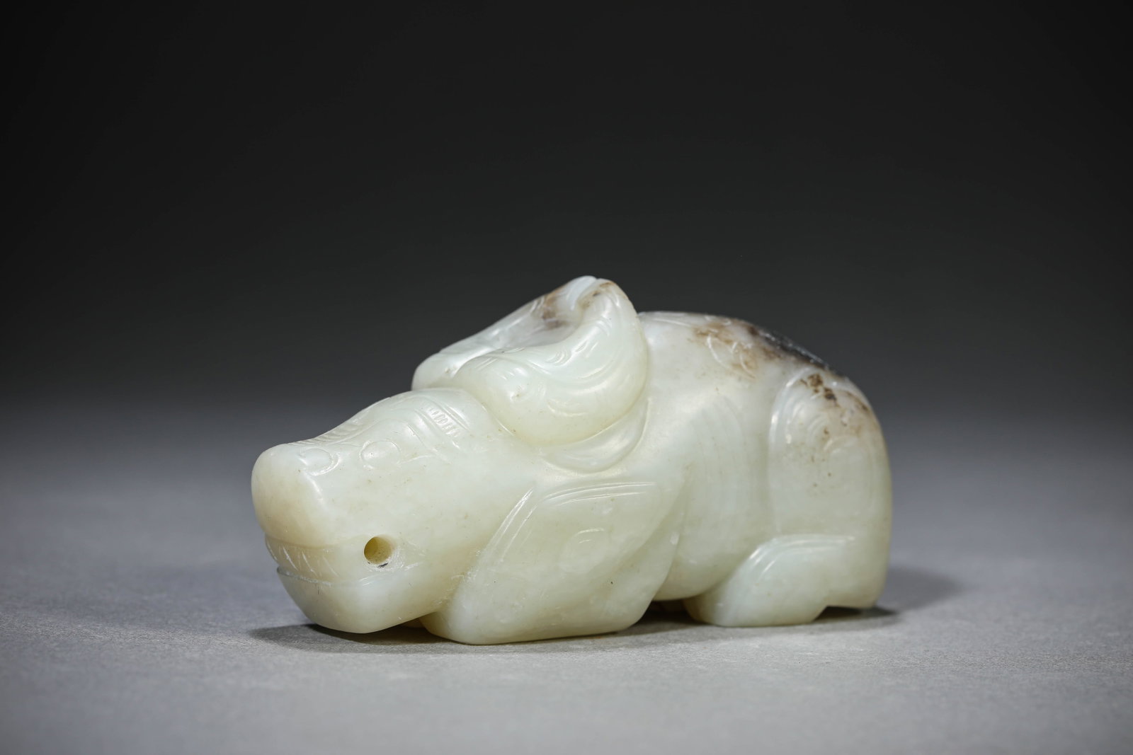 A Jade Buffalo: Dimensions: Length: 9.7 cm (3.82 in) x Width: 3.8 cm (1.50 in) x Height: 4.8 cm (1.89 in). All measurements are approximate.