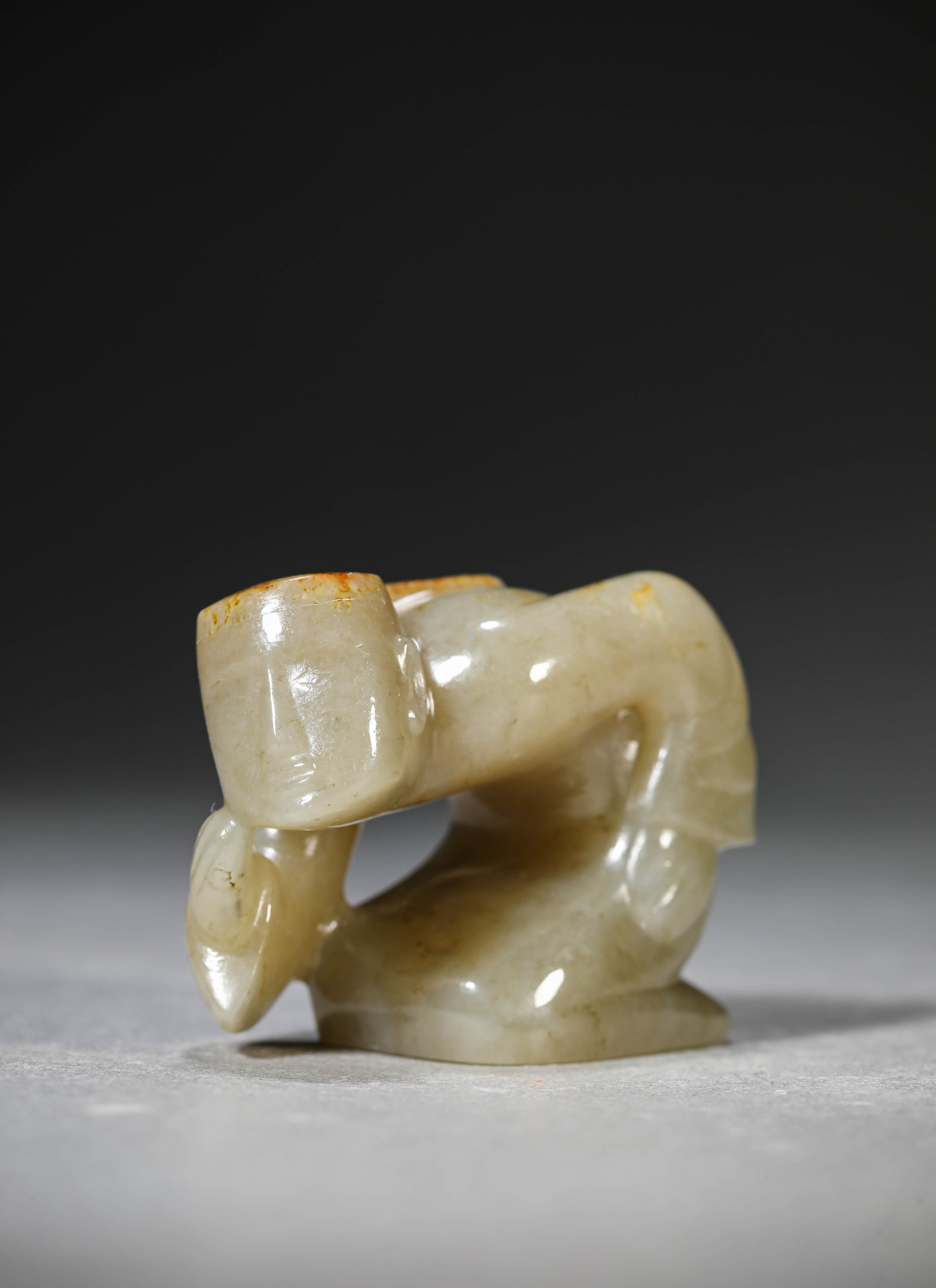 A Jade 'Kneeling Figure': Dimensions: Length: 5.8 cm (2.28 in) x Width: 2.8 cm (1.10 in) x Height: 4.3 cm (1.69 in). All measurements are approximate.