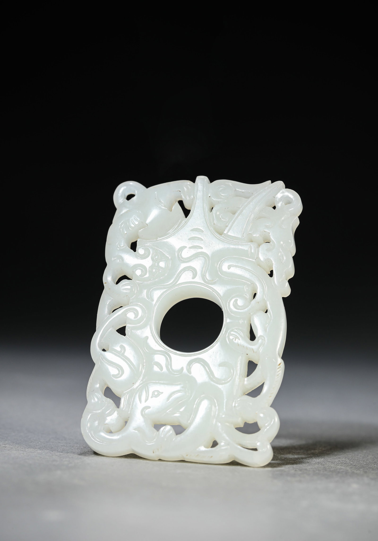 A Jade 'Chi-Dragon' Pendant: Dimensions: Width: 4.6 cm (1.81 in) x Height: 7.0 cm (2.76 in). All measurements are approximate.