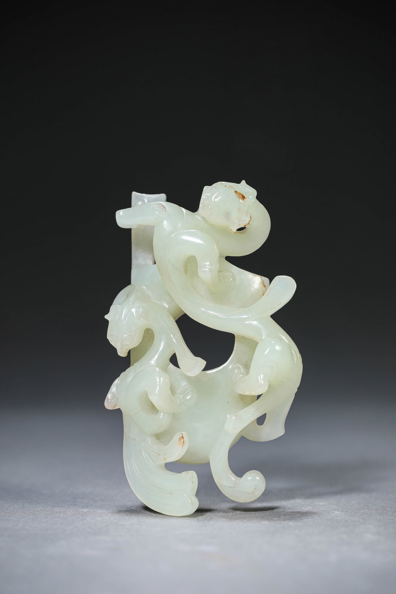 A Jade 'Heart-Shaped' Pendant: Dimensions: Length: 7.6 cm (2.99 in) x Width: 4.5 cm (1.77 in) x Height: 2.3 cm (0.91 in). All measurements are approximate.