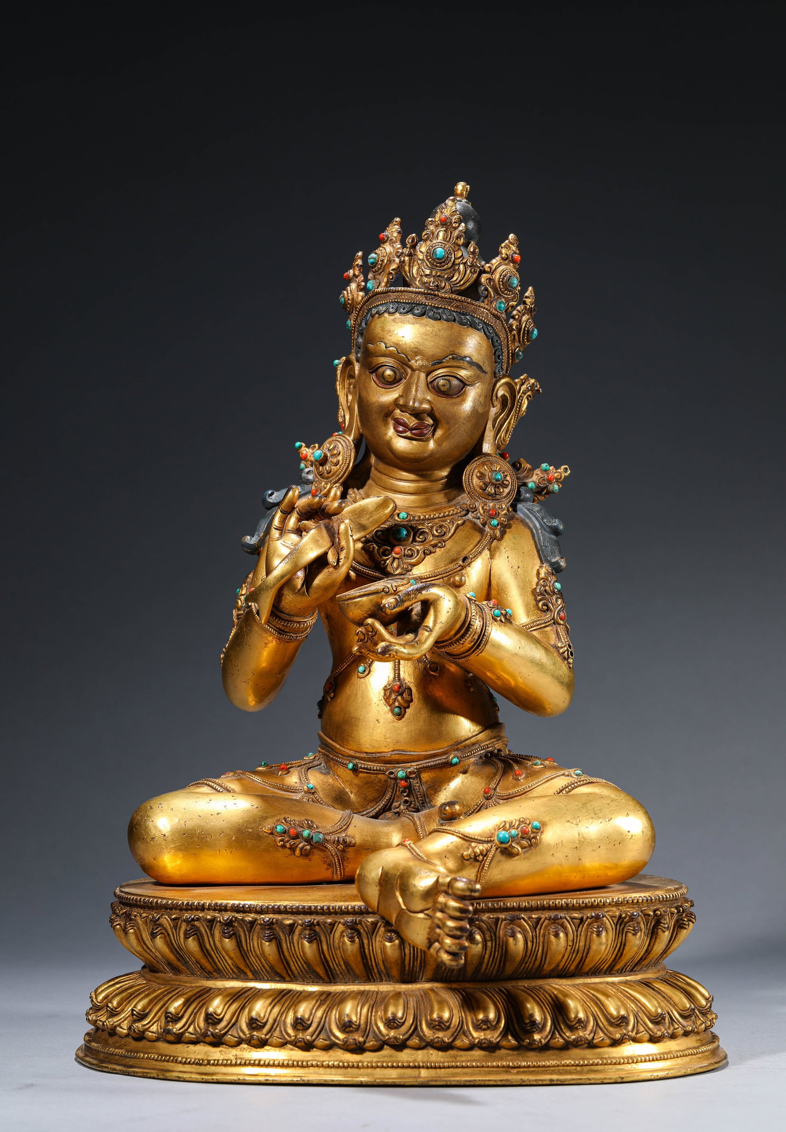 A Gilt-Bronze Figure of Yellow Jambhala: Dimensions: Weight: 7.3kg. Length: 26.5 cm (10.43 in) x Width: 23.5 cm (9.25 in) x Height: 37.0 cm (14.57 in). All measurements are approximate.