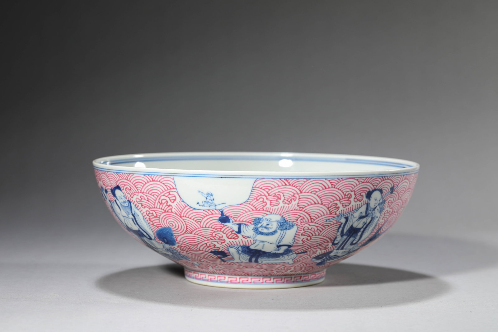 A Blue and White and Rouge 'Eight Immortals Crossing the Sea' Bowl: Dimensions: Width: 22.2 cm (8.74 in) x Height: 8.0 cm (3.15 in). All measurements are approximate.