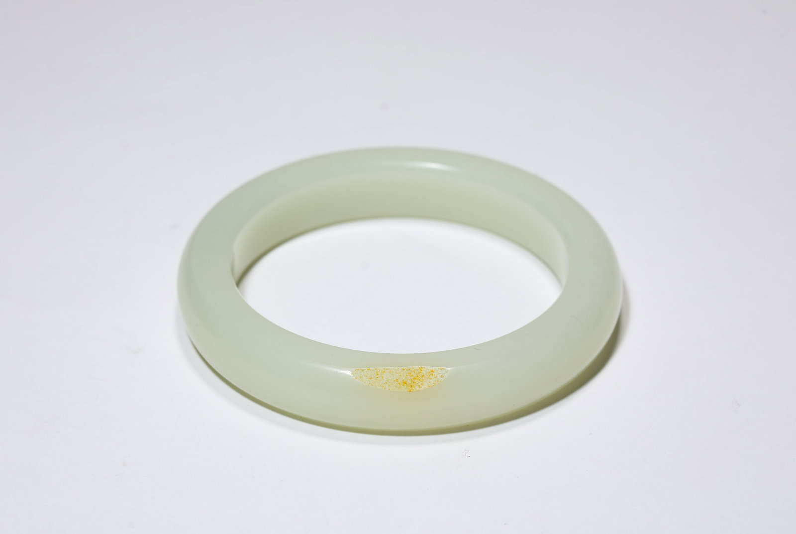 A Jade Bangle: Dimensions: Width: 5.7 cm (2.24 in). All measurements are approximate.
