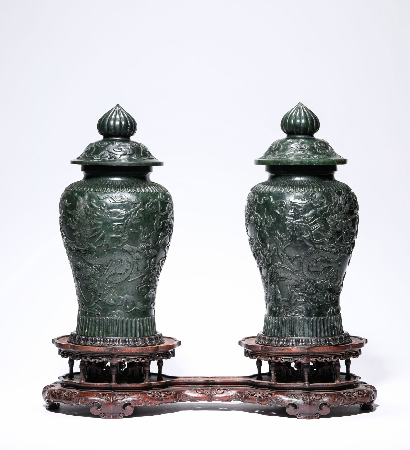 A Pair of Spinach Jade 'Two Dragons Chasing a Pearl' Vases: Dimensions: Width: 11.5 cm (4.53 in) x Height: 2.8 cm (1.10 in). All measurements are approximate.