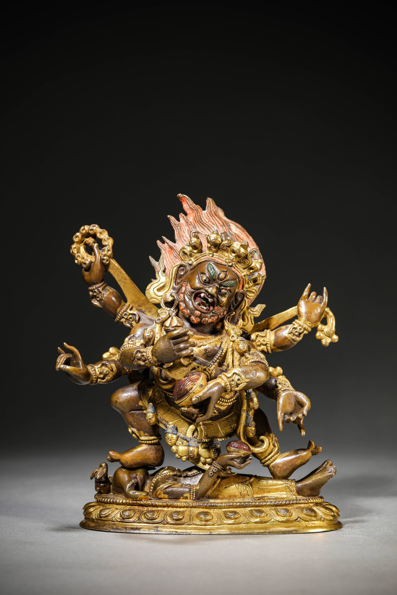 A Gilt-Bronze Figure of Six-Armed Mahakala: Dimensions: Weight: 1688g. Length: 16.1 cm (6.34 in) x Width: 6.7 cm (2.64 in) x Height: 16.7 cm (6.57 in). All measurements are approximate.