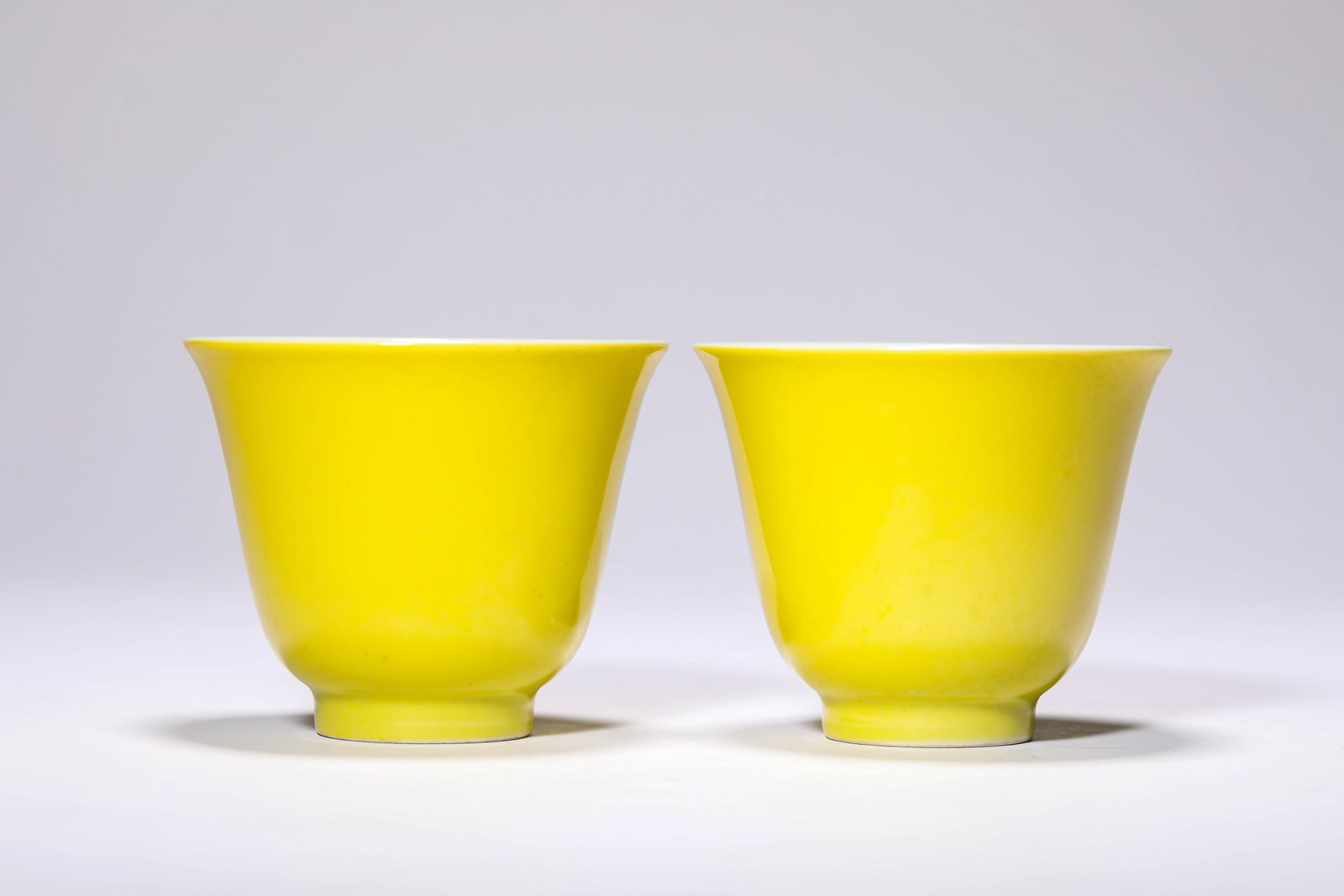A Pair of Lemon-Yellow-Ground Small Cups: Dimensions: Width: 8.5 cm (3.35 in) x Height: 7.0 cm (2.76 in). All measurements are approximate.