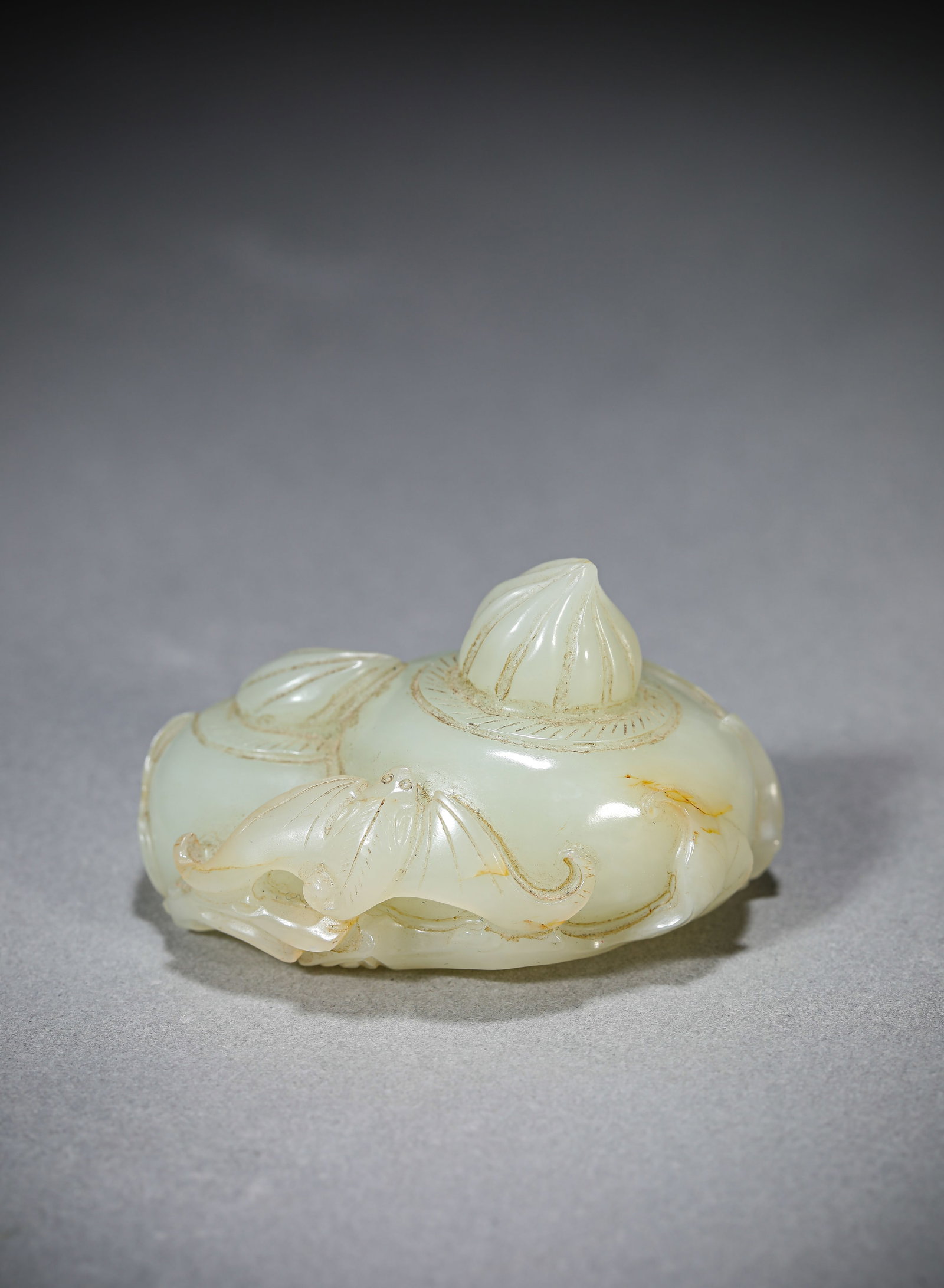 A Jade 'Bat and Shou' Ornament: Dimensions: Length: 5.6 cm (2.20 in) x Width: 4.2 cm (1.65 in) x Height: 3.4 cm (1.34 in). All measurements are approximate.
