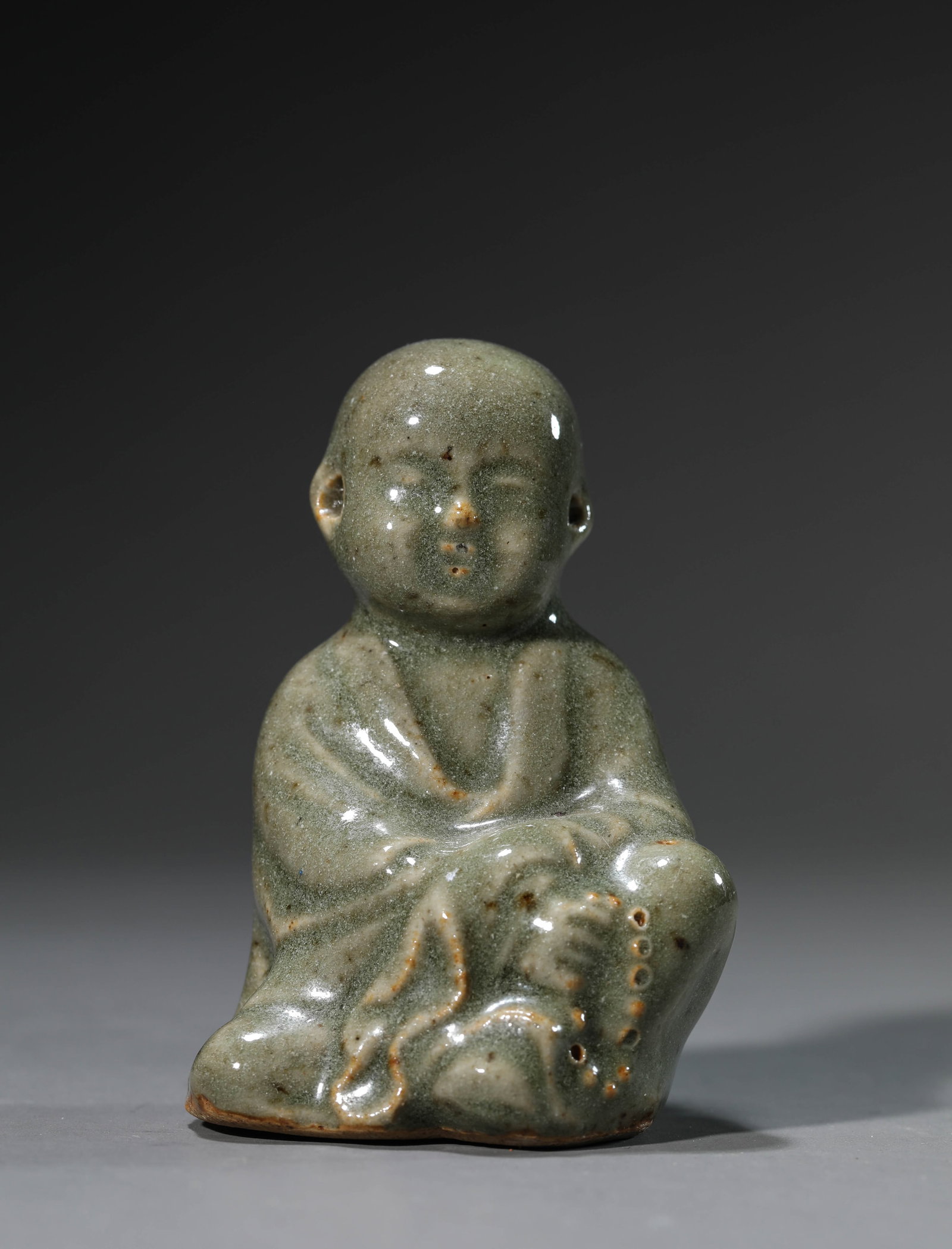 A Celadon-Glazed 'Figural' Ornament: Dimensions: Length: 6.0 cm (2.36 in) x Width: 4.5 cm (1.77 in) x Height: 7.6 cm (2.99 in). All measurements are approximate.