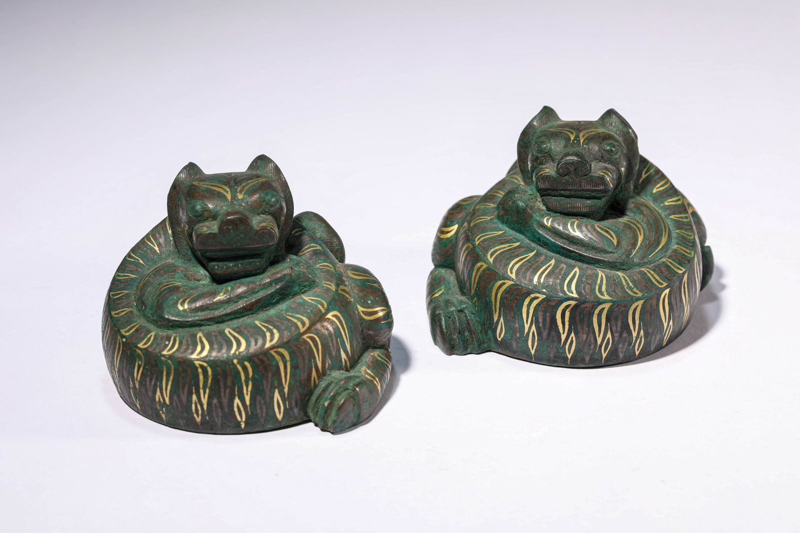 A Gold and Silver-Inlaid Bronze 'Tiger-Form' Paperweight: Dimensions: Weight: 1949g. Width: 8.3 cm (3.27 in) x Height: 6.1 cm (2.40 in). All measurements are approximate.
